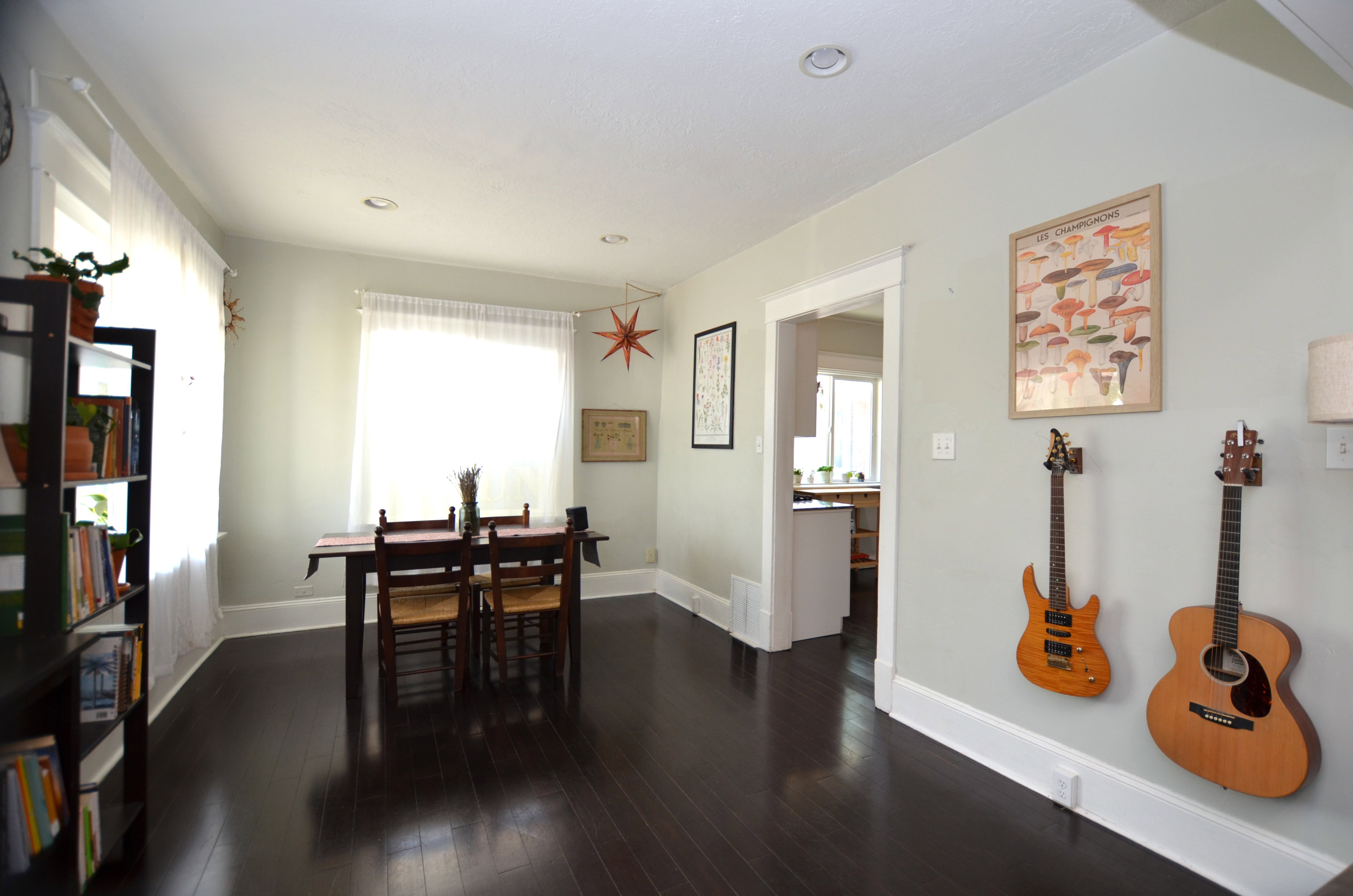 Dark wood-finish flooring extending throughout, recessed lighting, and bright white trim