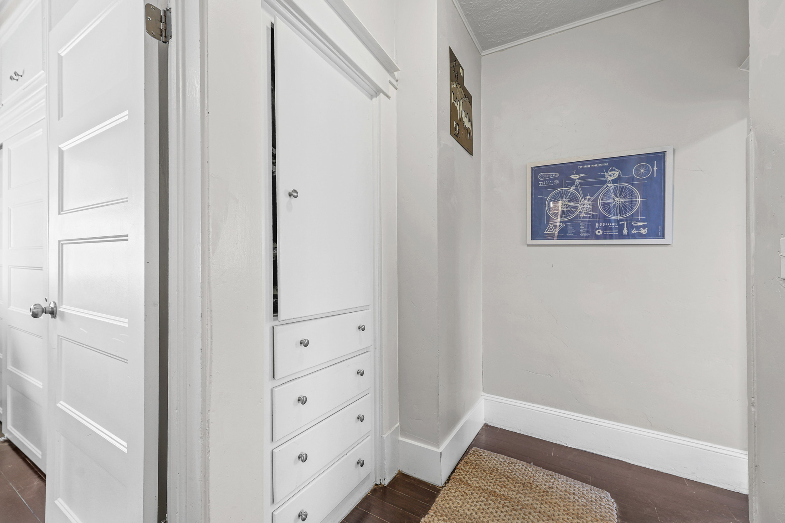 Built-in cabinetry featuring multiple drawers and an upper storage compartment