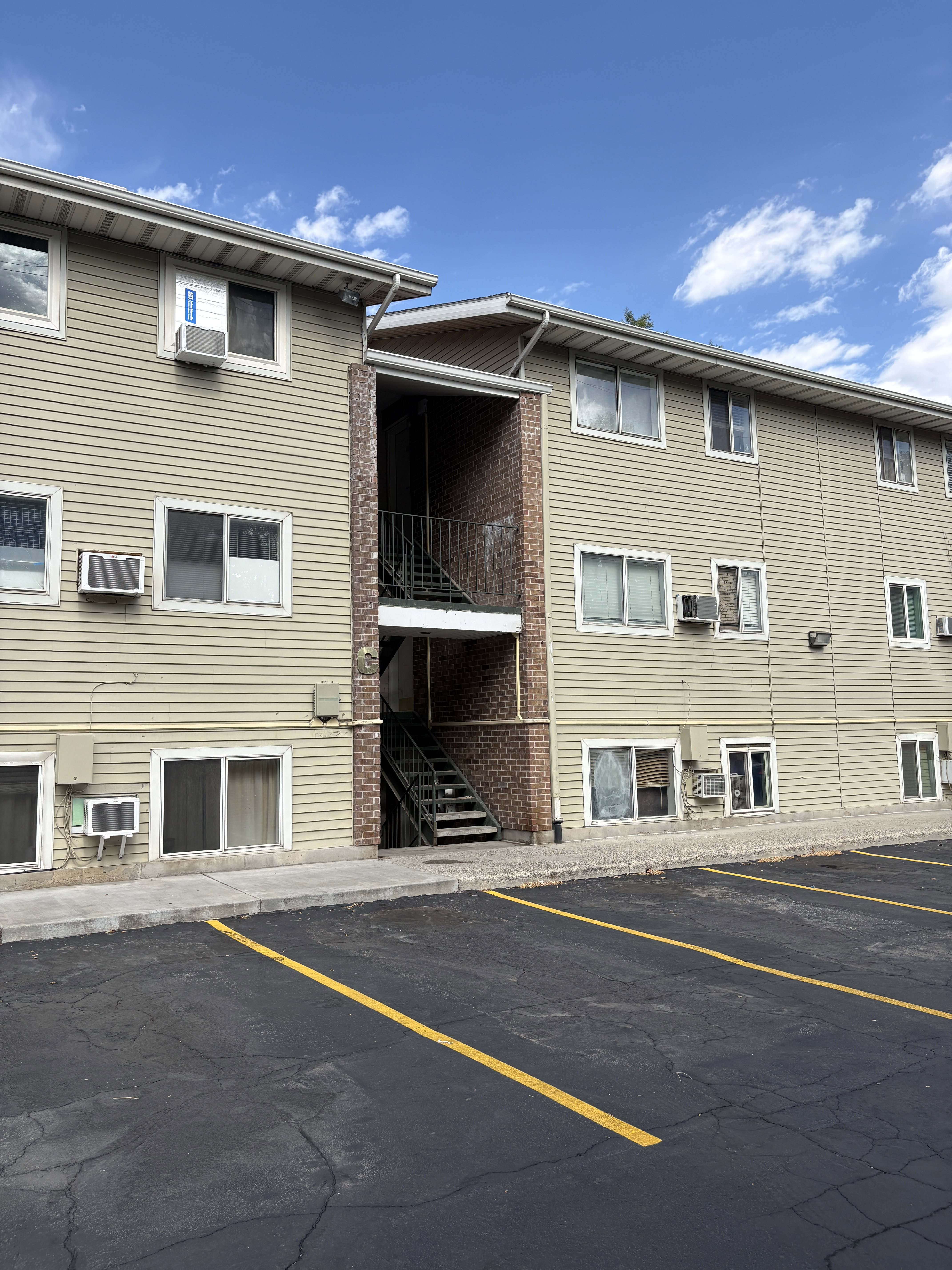 Multi-level building with horizontal siding and prominent window units