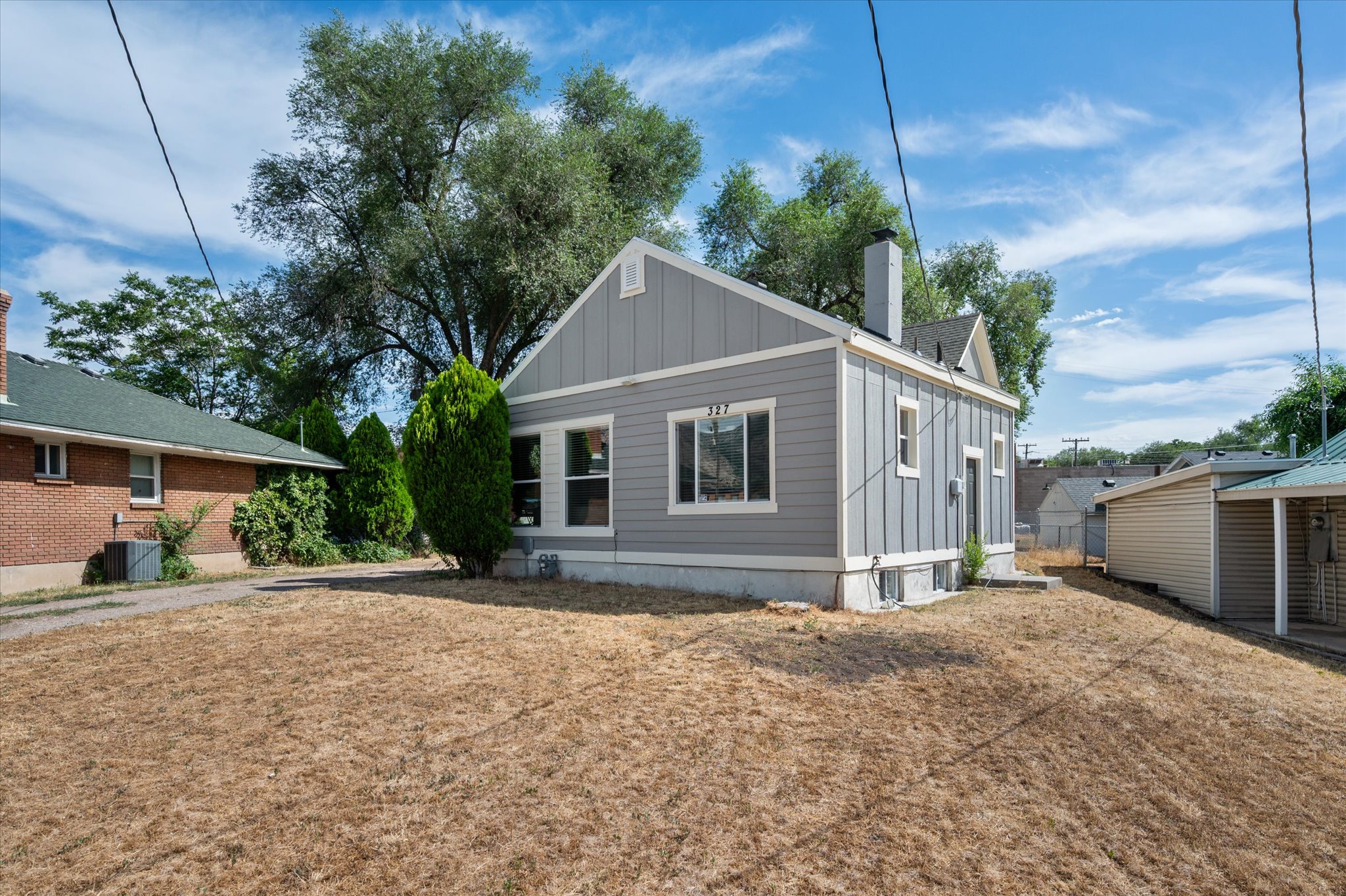 Single-story property with gray horizontal siding and vertical board and batten accents