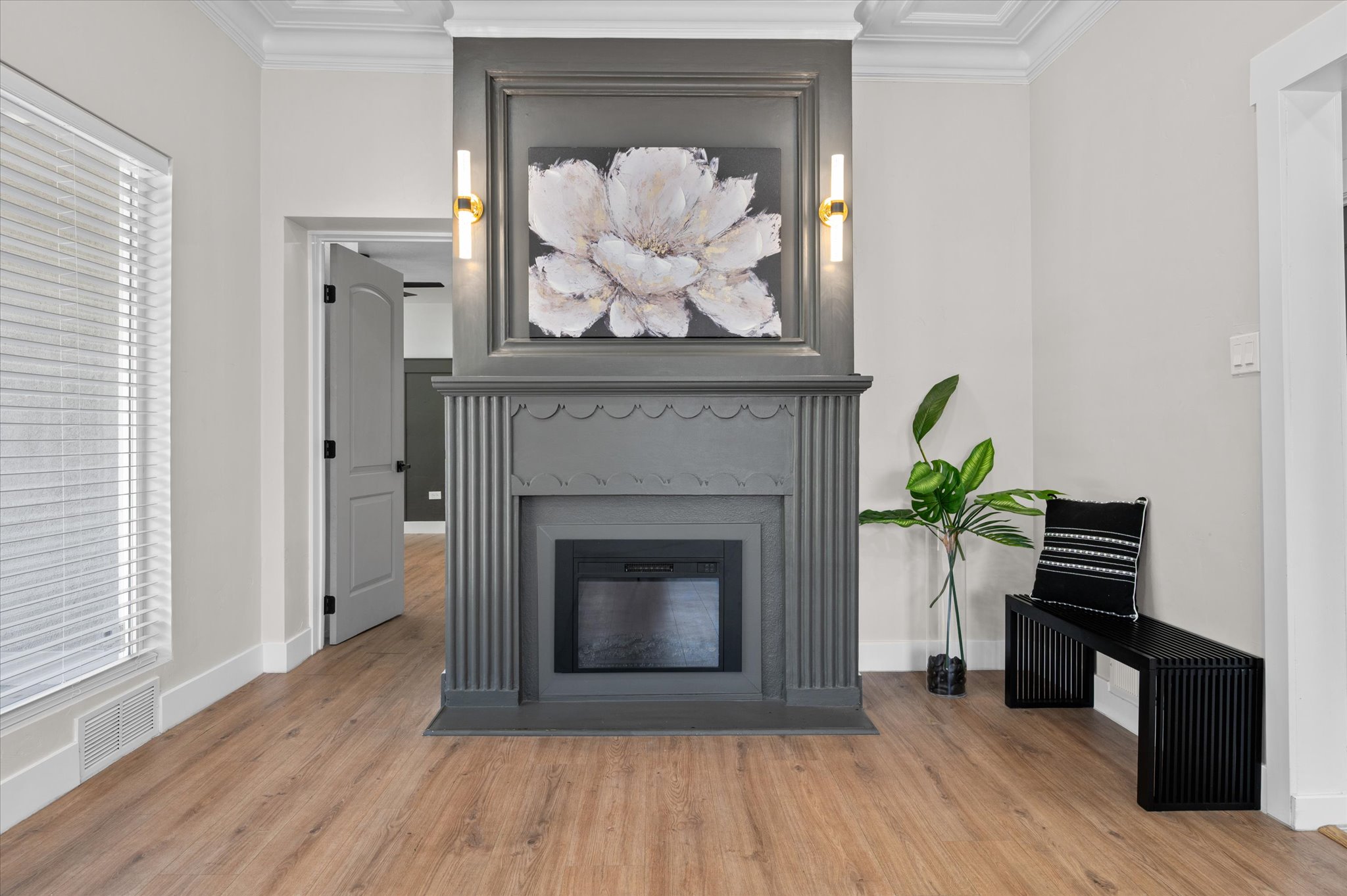 Central fireplace featuring a gray mantel with decorative fluting and a recessed electric insert