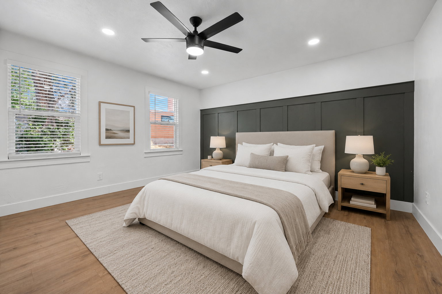 Expansive room featuring wood-finish flooring, recessed lighting, and a black ceiling fan