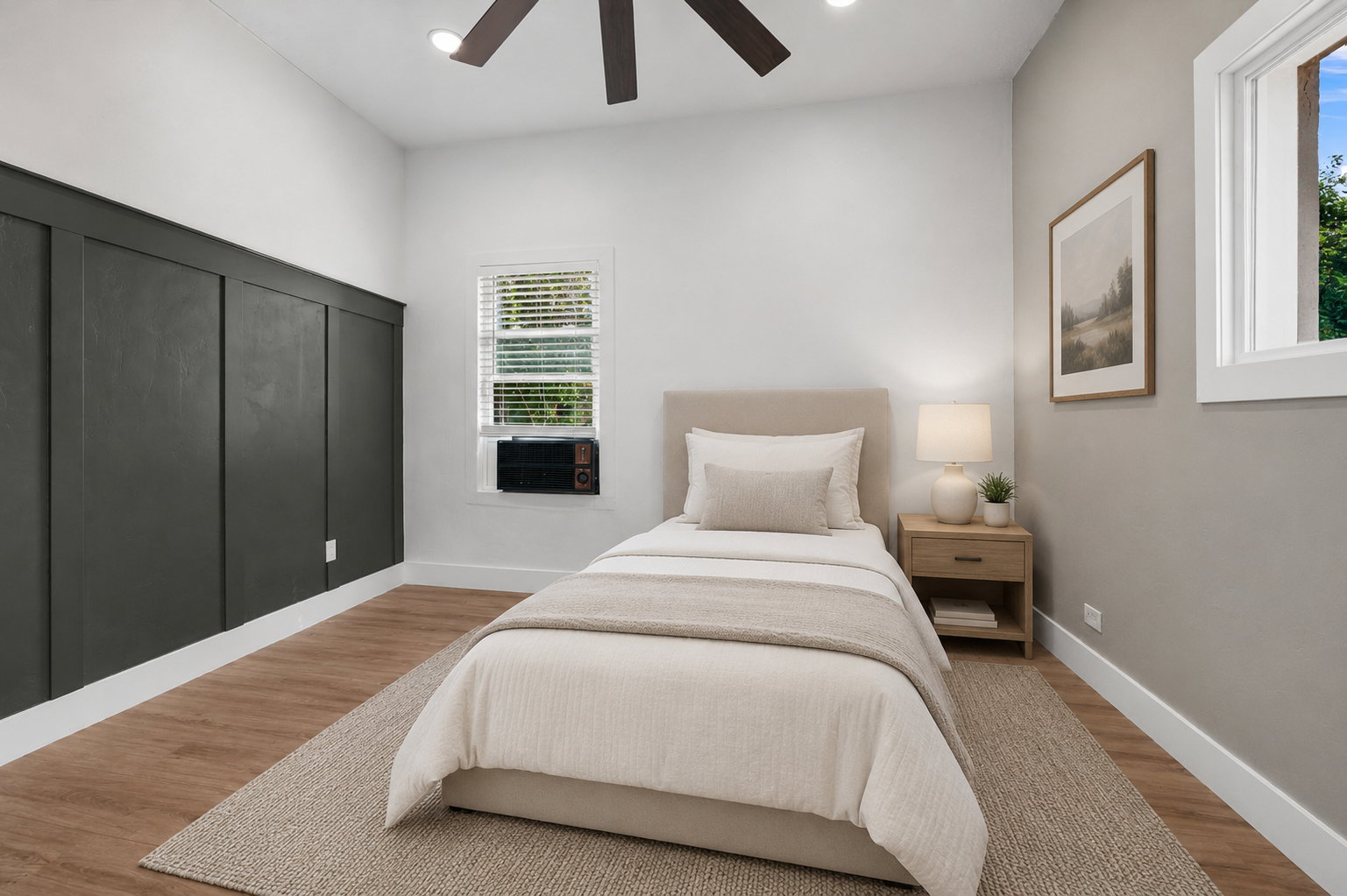 Bedroom featuring a decorative board and batten accent wall, wood-finish flooring, and a ceiling fan with integrated lighting