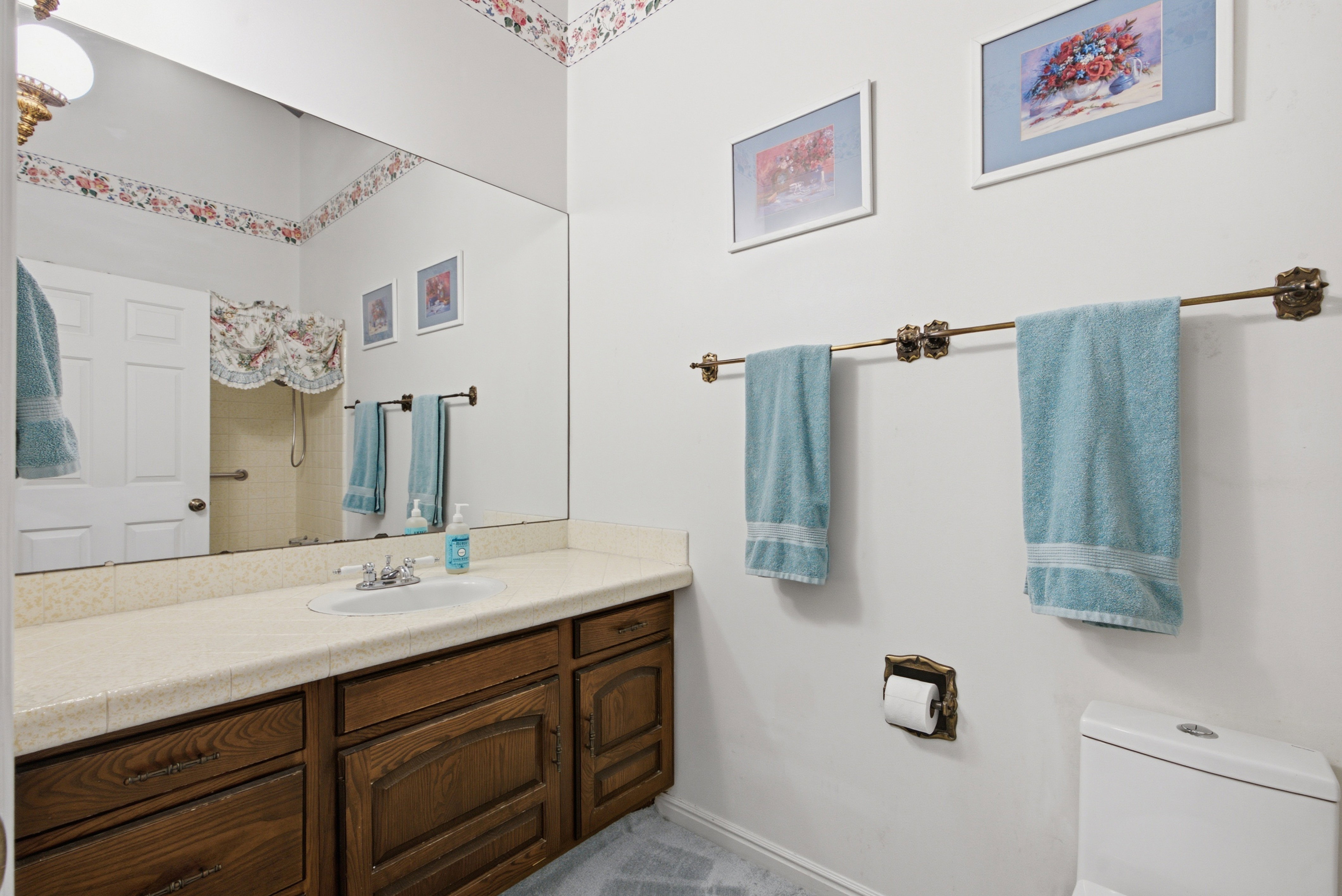 Bathroom featuring a vanity with dark wood-finish cabinetry and a light-toned countertop