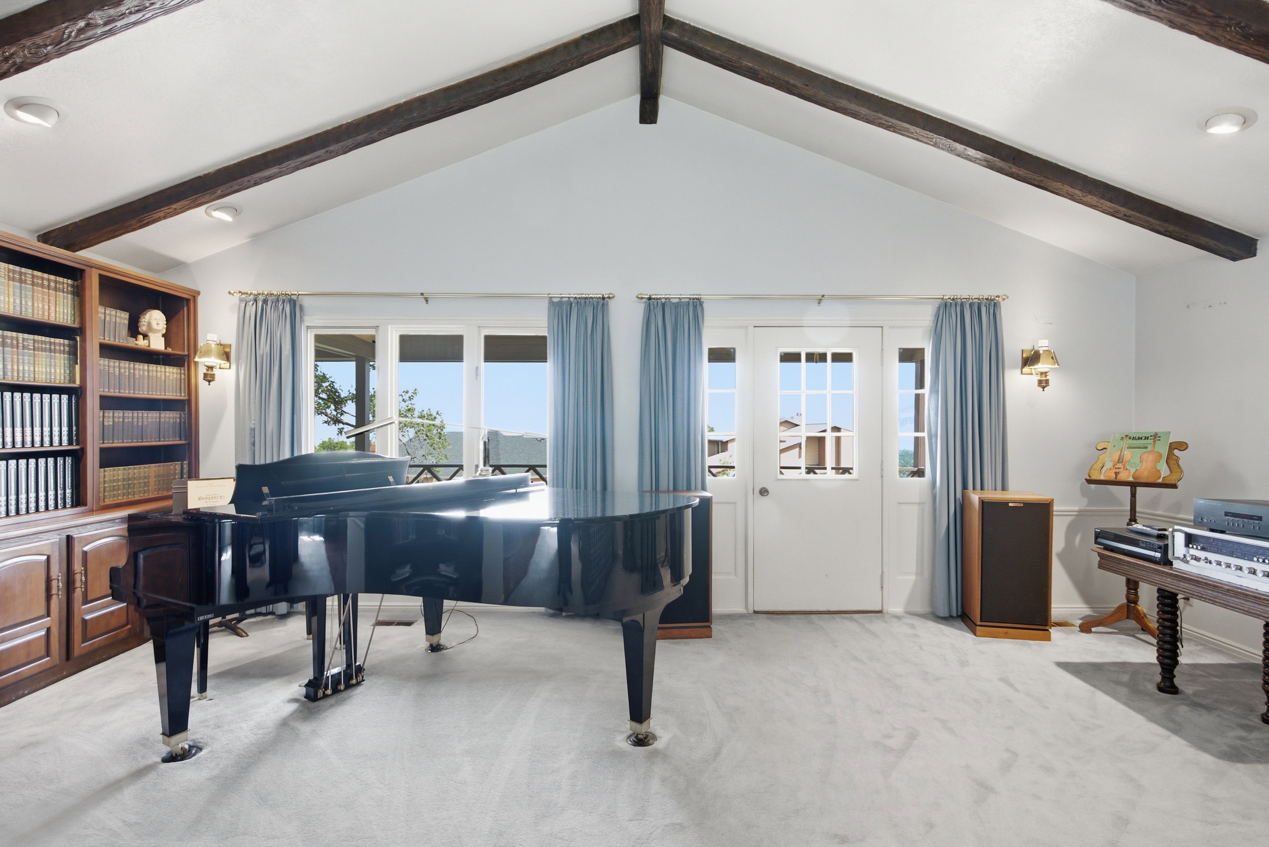 Vaulted ceiling featuring exposed wood beams
