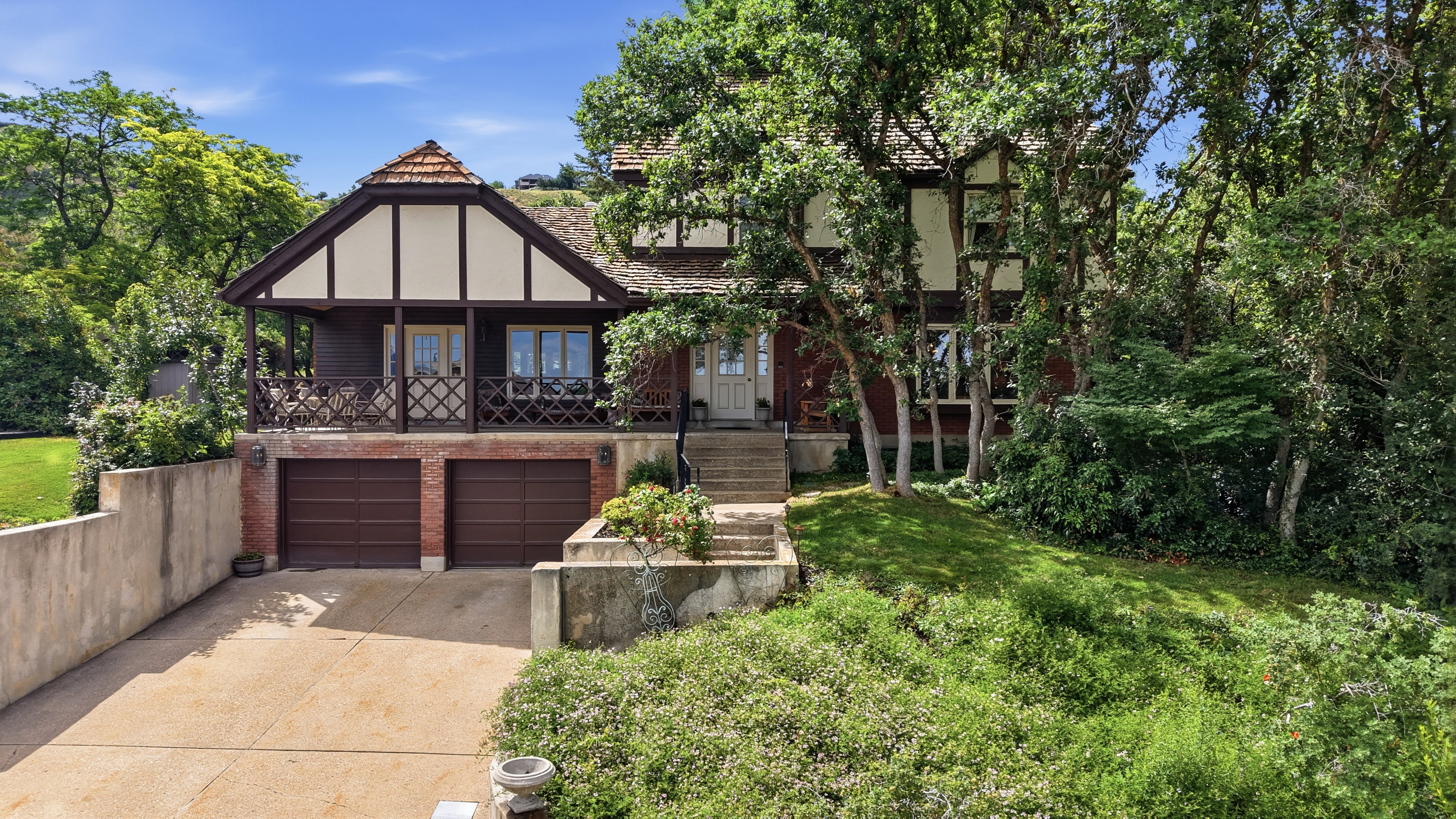 Tudor-style residence featuring a prominent gabled roof with wood shake shingles