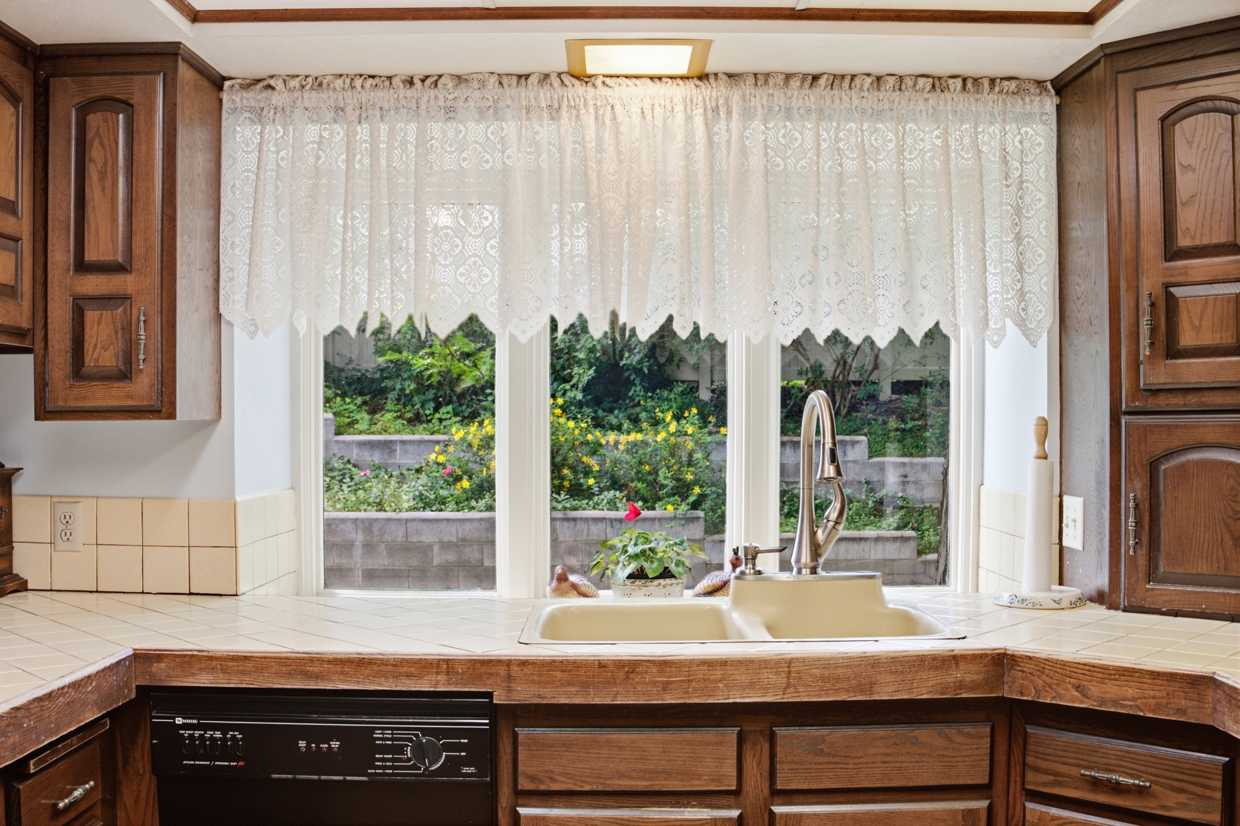 Kitchen window overlooking exterior landscaping