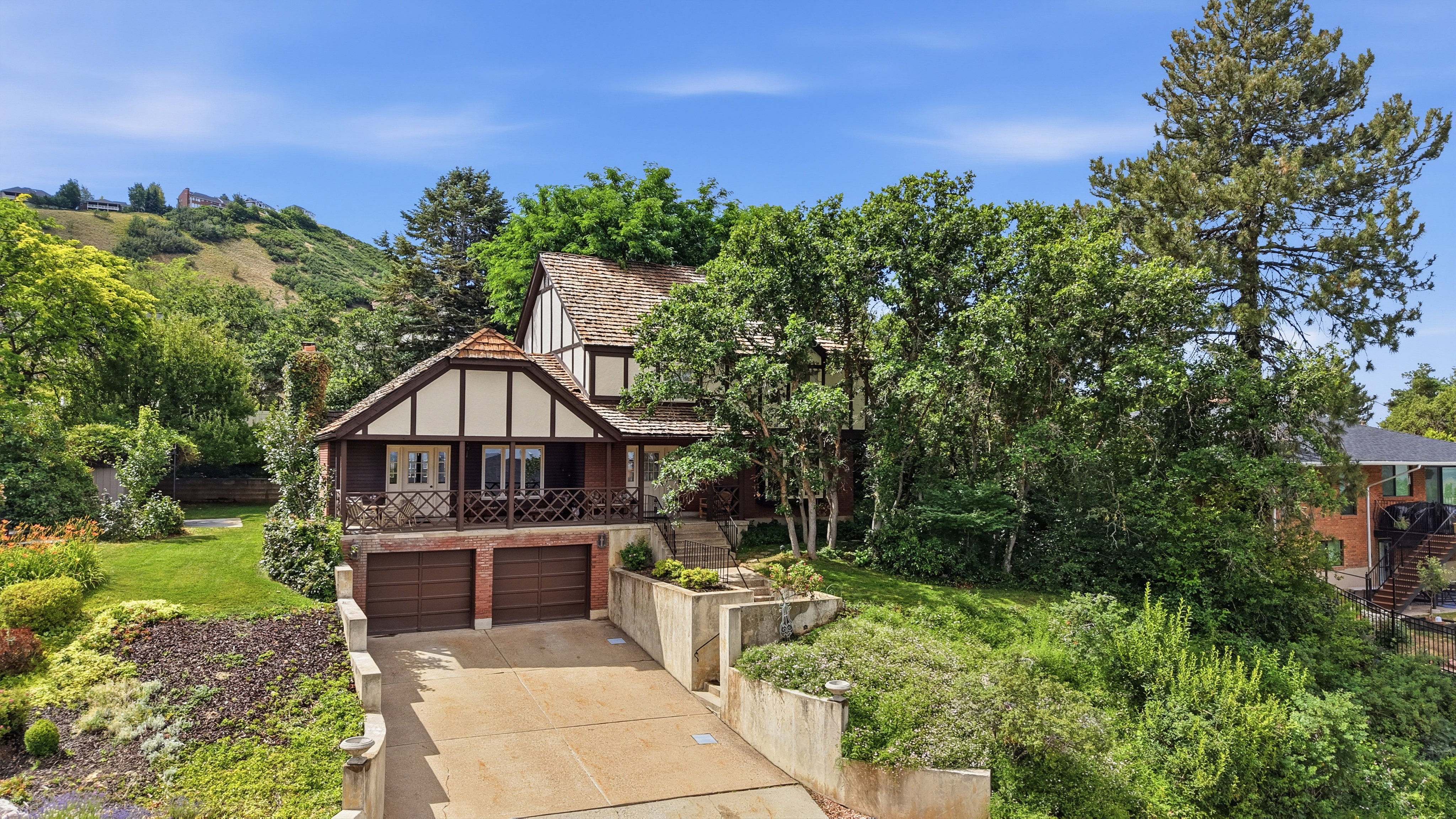 Tudor-style exterior with wood-frame detailing and a wood shake shingle roof