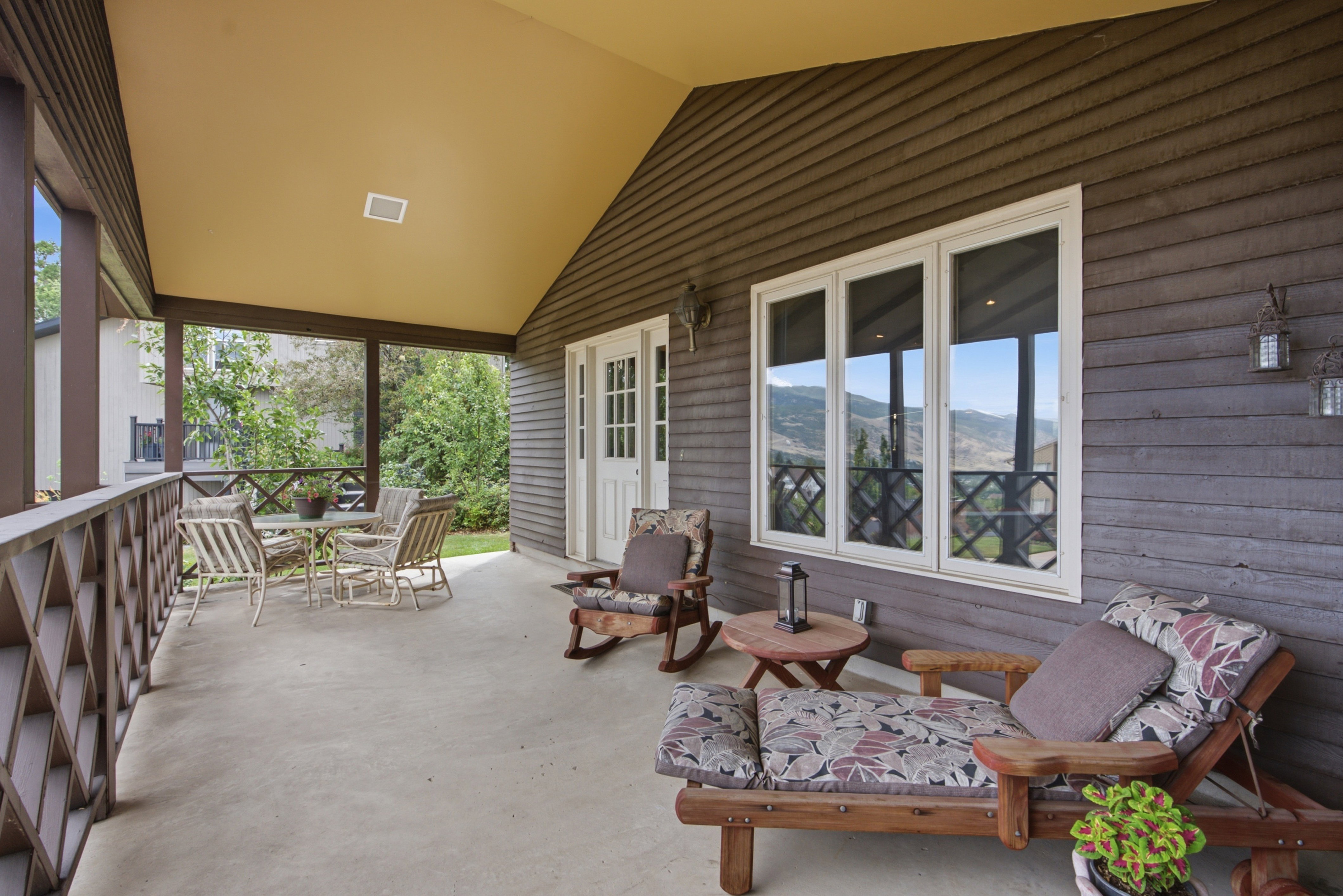 Covered concrete patio with wood-finish siding and a light-colored ceiling
