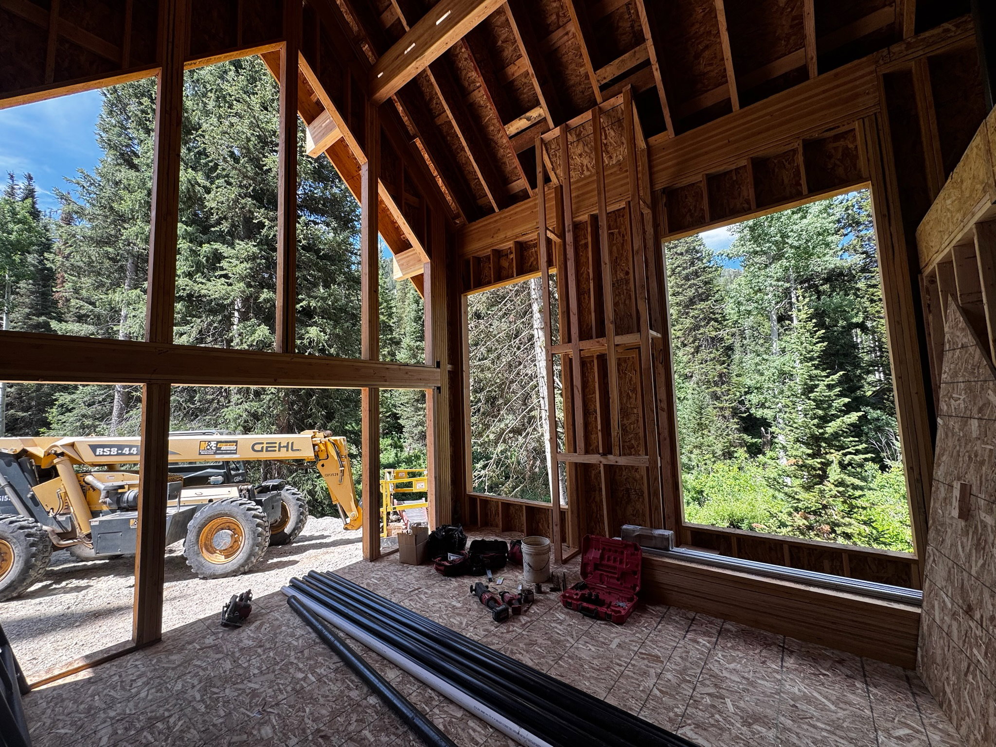 Construction progress highlighting the expansive glass openings designed to capture natural light and peaceful wooded views.