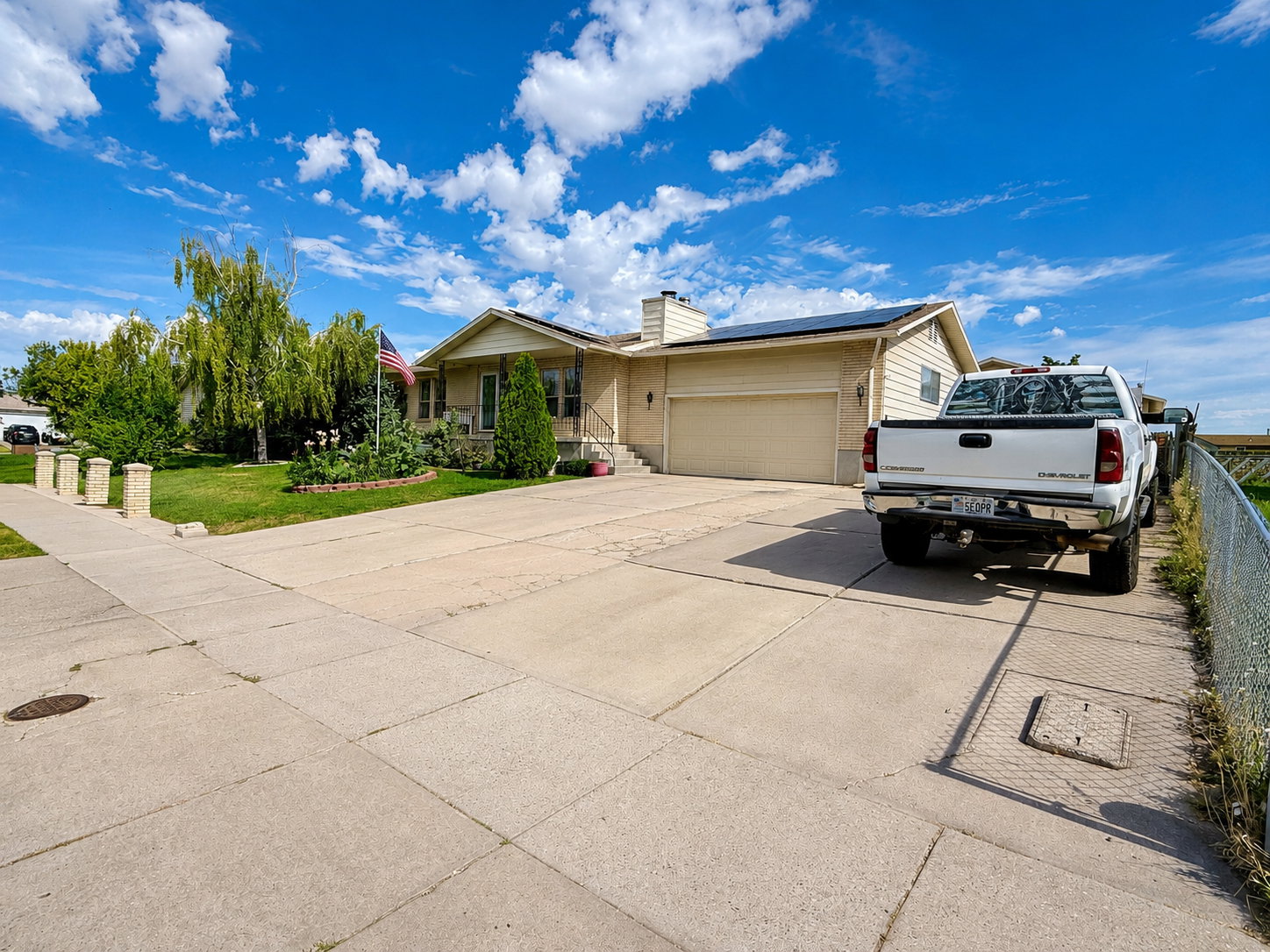 Residential property featuring a beige exterior with siding and a two-car garage