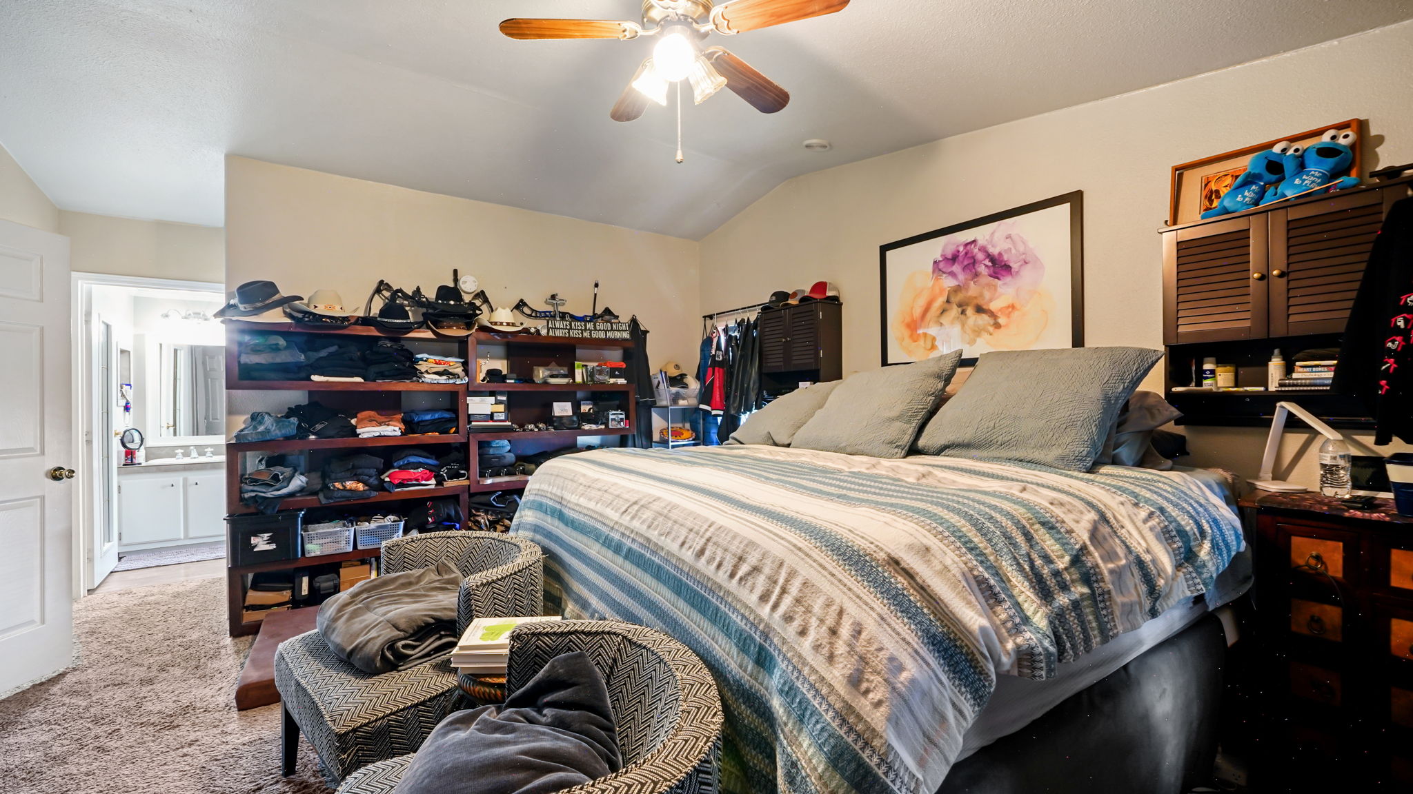 Carpeted room featuring a vaulted ceiling and a ceiling fan with integrated lighting