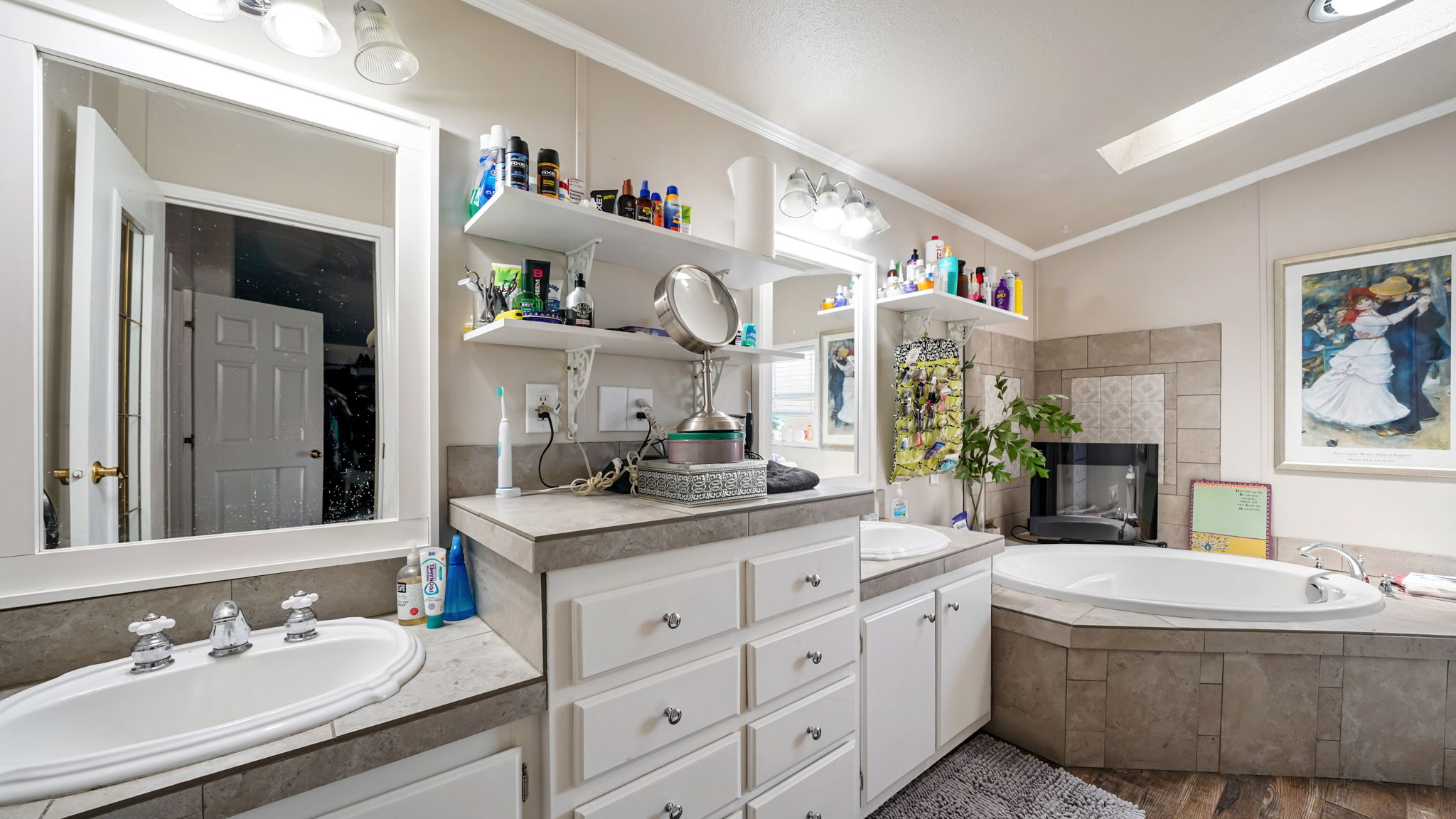 Dual vanity with integrated sinks, white cabinetry, and gray countertops