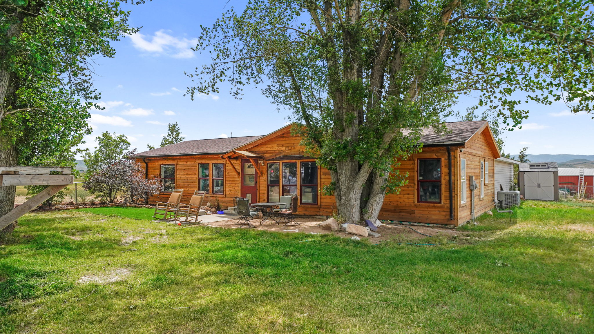 Exterior wood-sided residence with multiple windows and a shingled roof