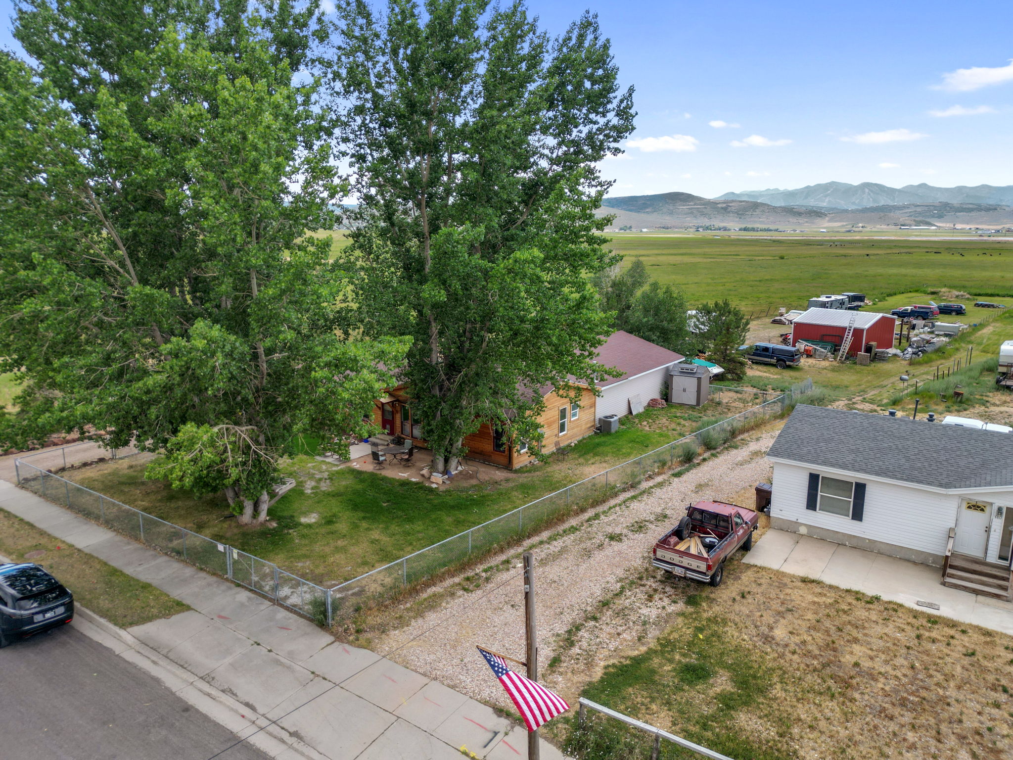 Property situated on a green lawn with mature trees