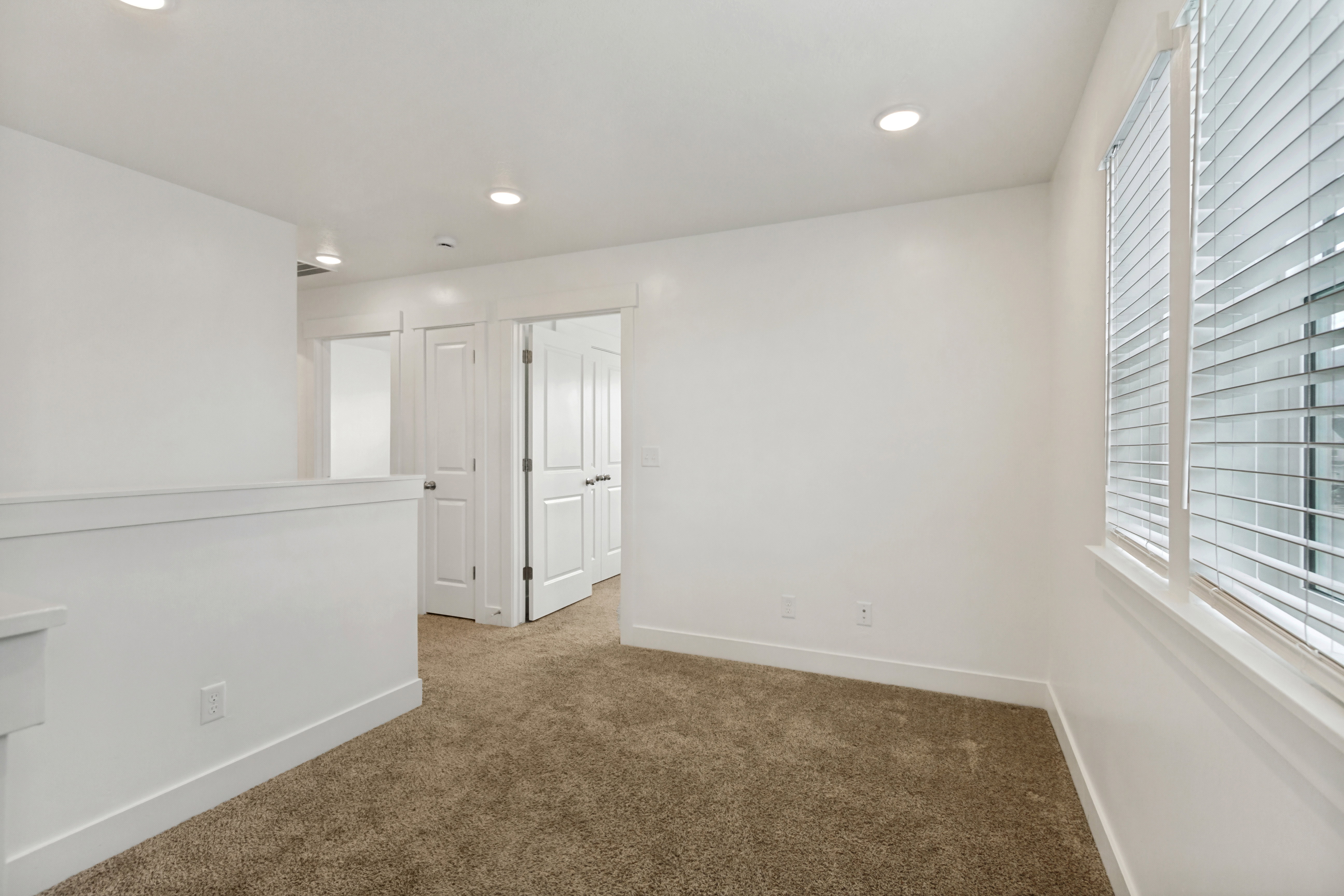 Loft featuring white walls, recessed lighting