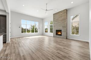 Spacious living area featuring high ceilings, recessed lighting, and wood-finish flooring