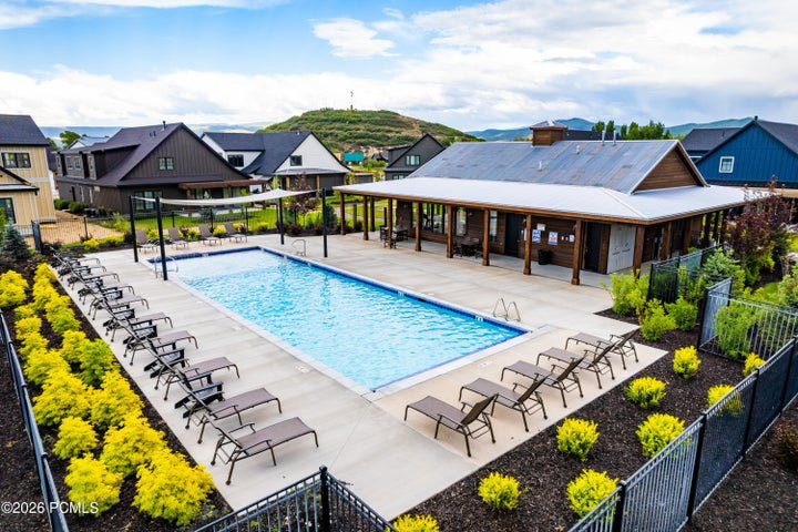 Outdoor swimming pool with integrated spa and surrounding concrete patio