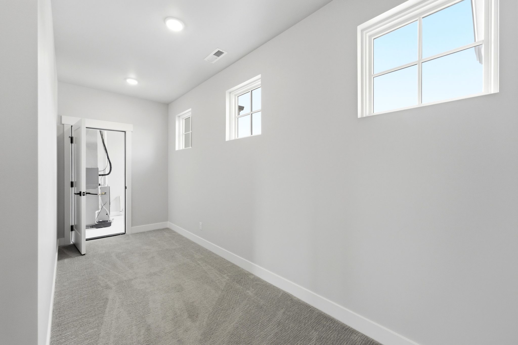 Room featuring gray carpeting, white baseboards, and light gray wall paint