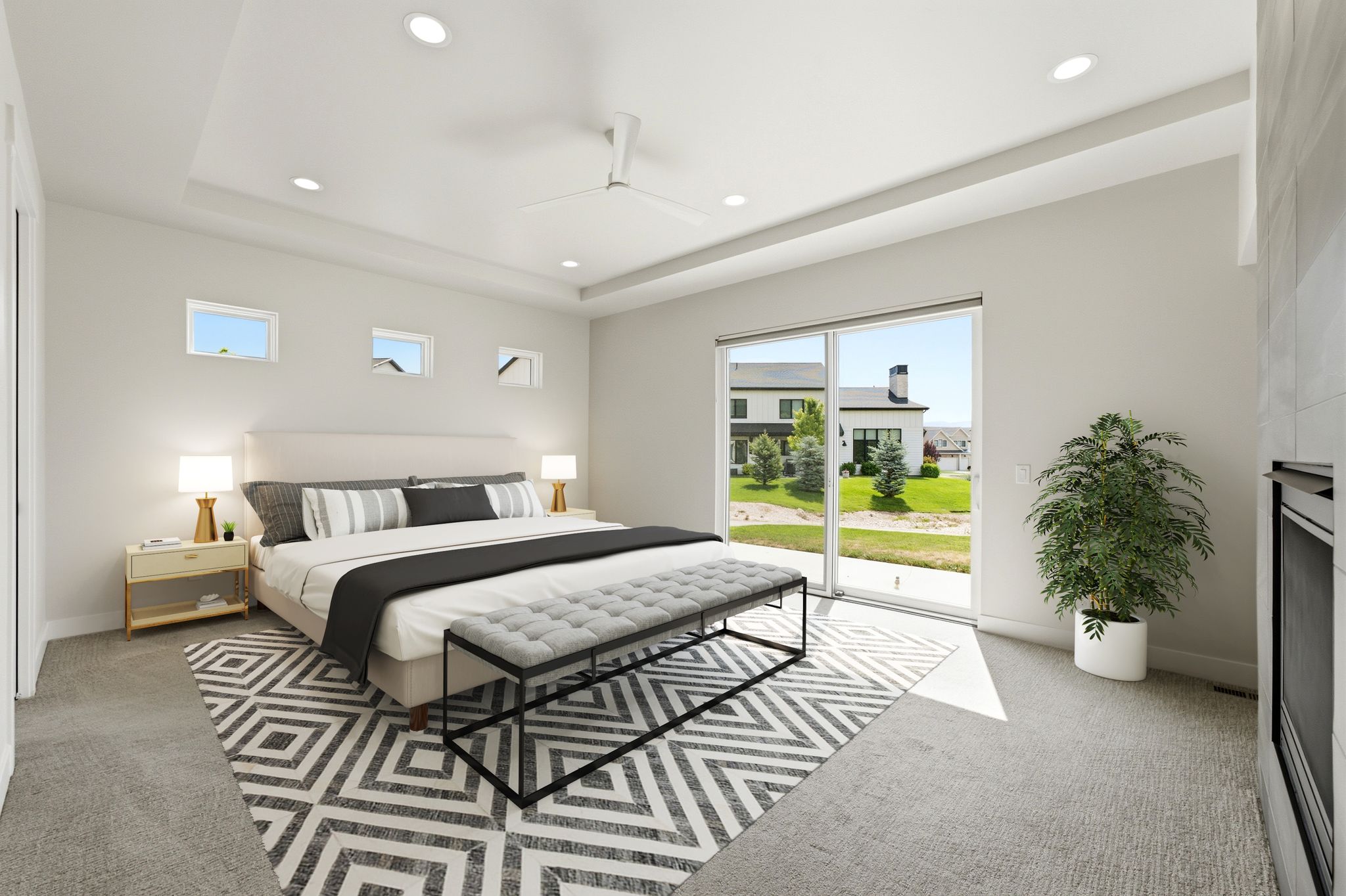 Spacious room featuring a tray ceiling, recessed lighting, ceiling fan, and large sliding glass door