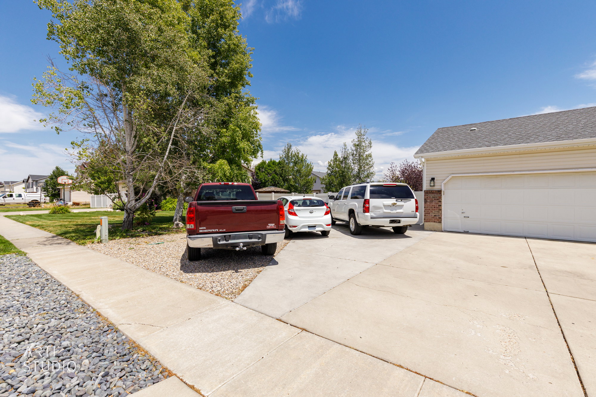 Two-car garage with white panel doors and an exterior light fixture