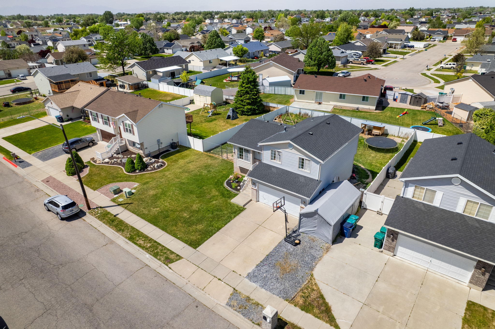 Suburban residential street featuring multiple single-family homes with pitched roofs and attached garages