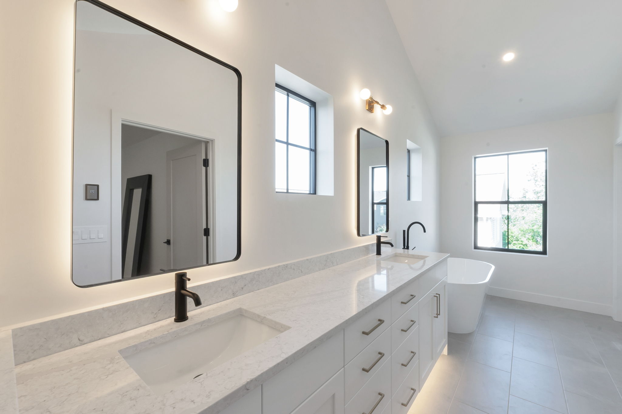 Dual vanity featuring light-colored countertops and undermount sinks