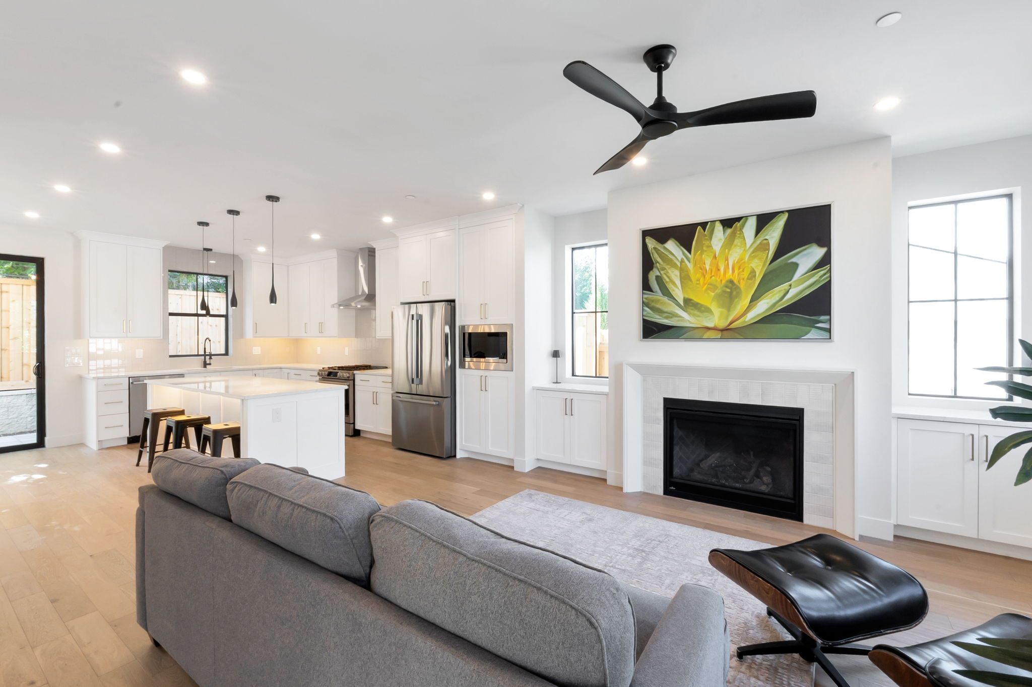 Open-concept living space with light wood-finish flooring