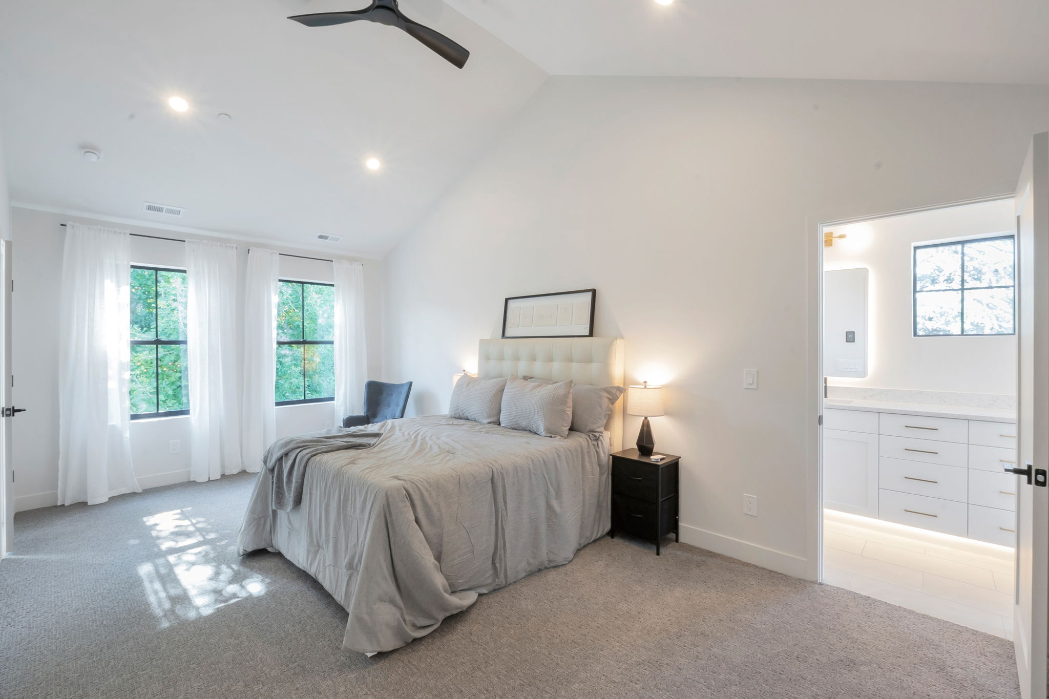 Vaulted ceiling with a contemporary ceiling fan and recessed lighting