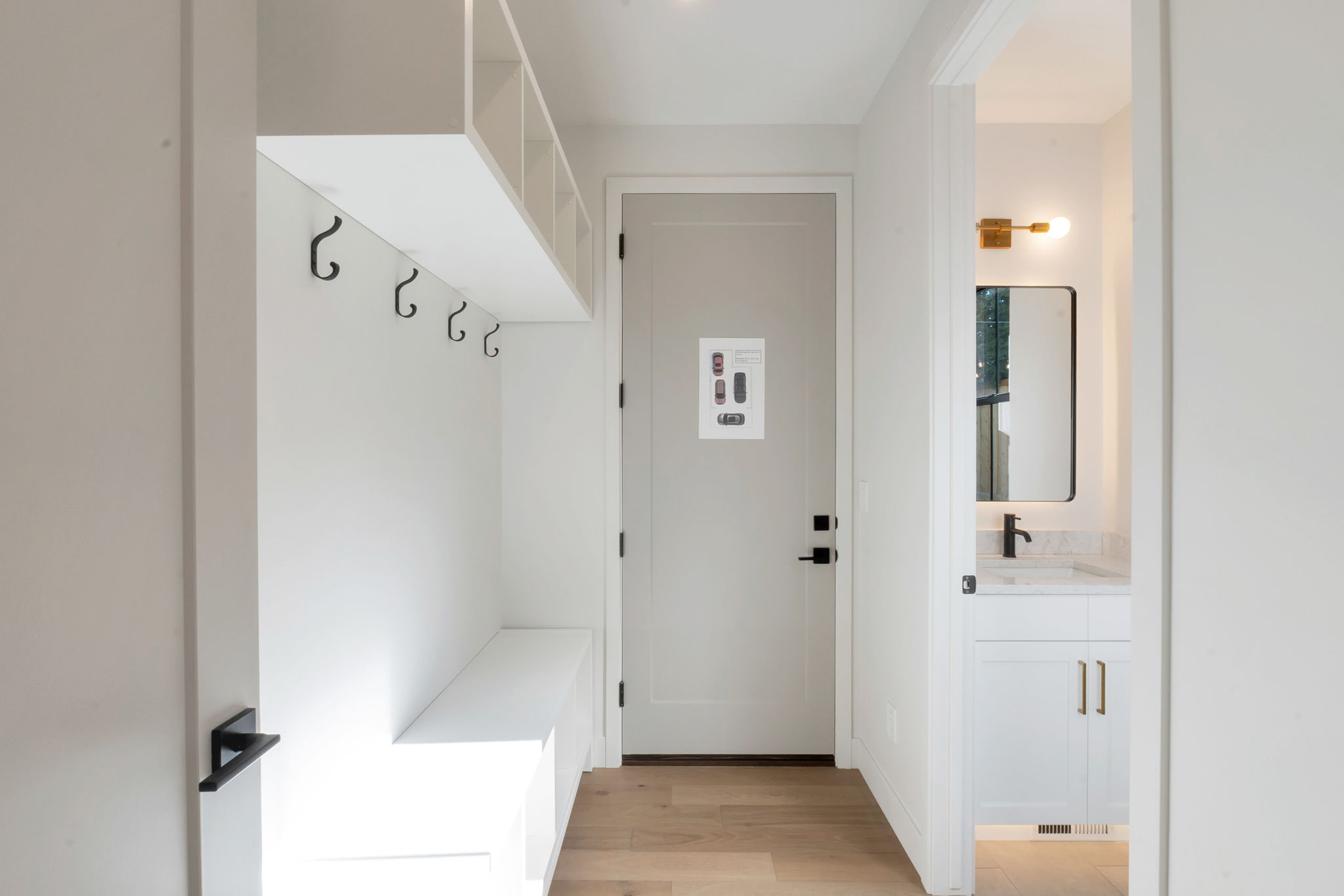 Entryway featuring built-in bench seating, upper cubbies, and coat hooks