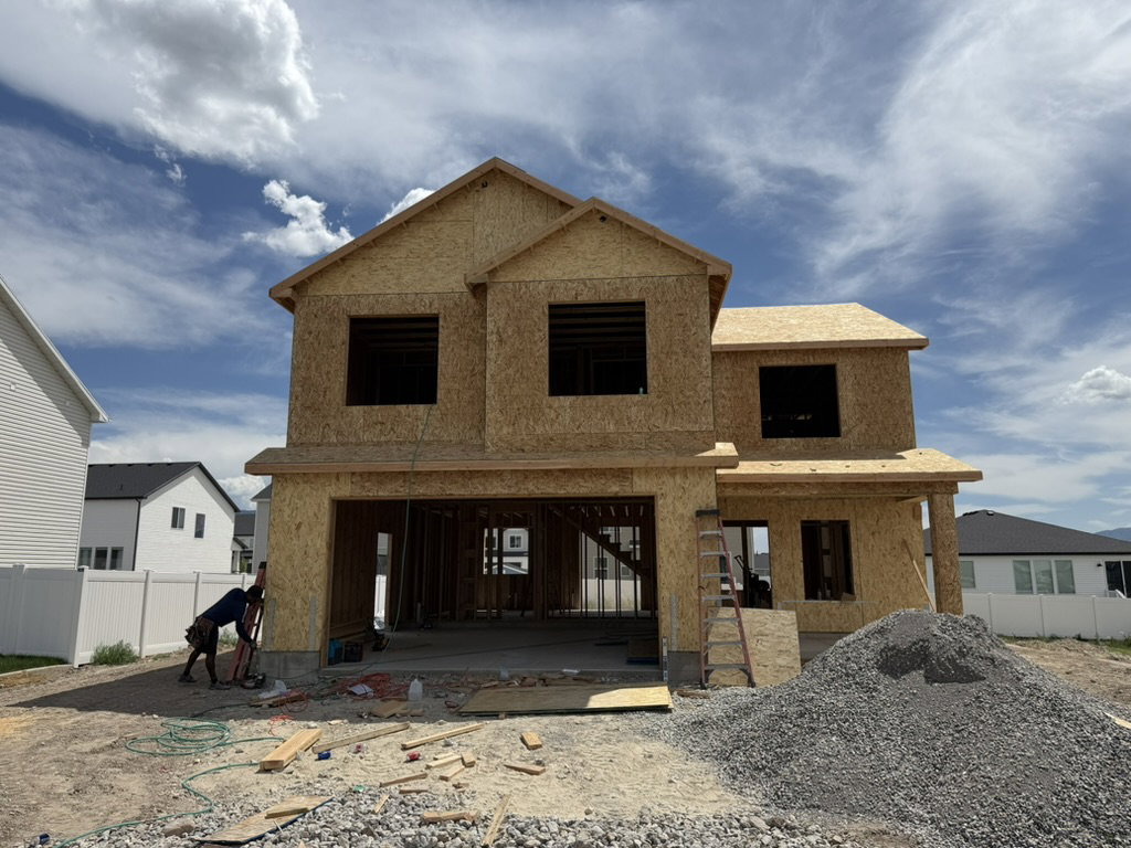 New construction residential property featuring a two-story design, attached two-car garage, and a covered entry