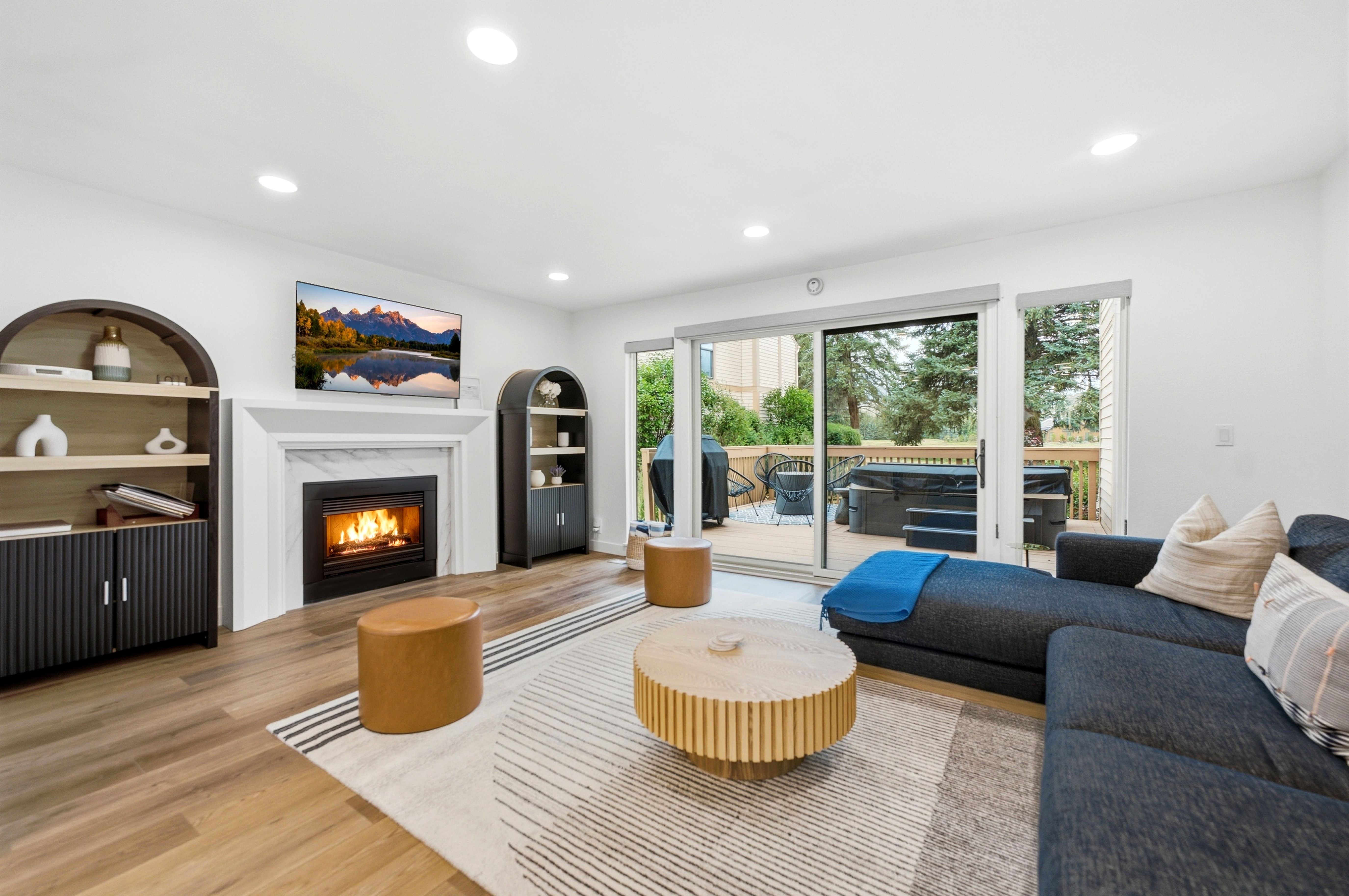 Living area with wood-finish flooring and recessed lighting
