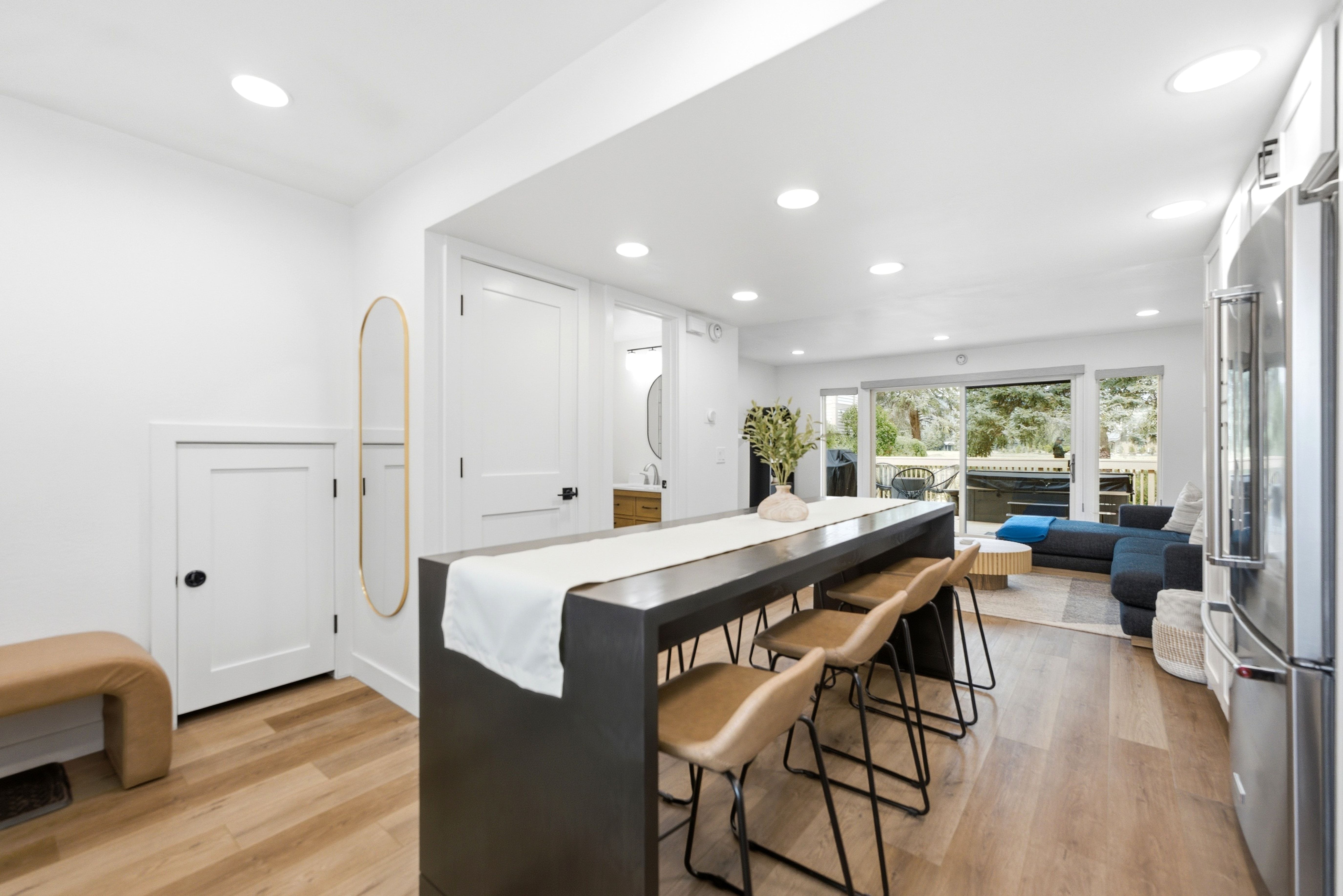 Open-concept living space featuring wood-finish flooring, recessed lighting, and white walls
