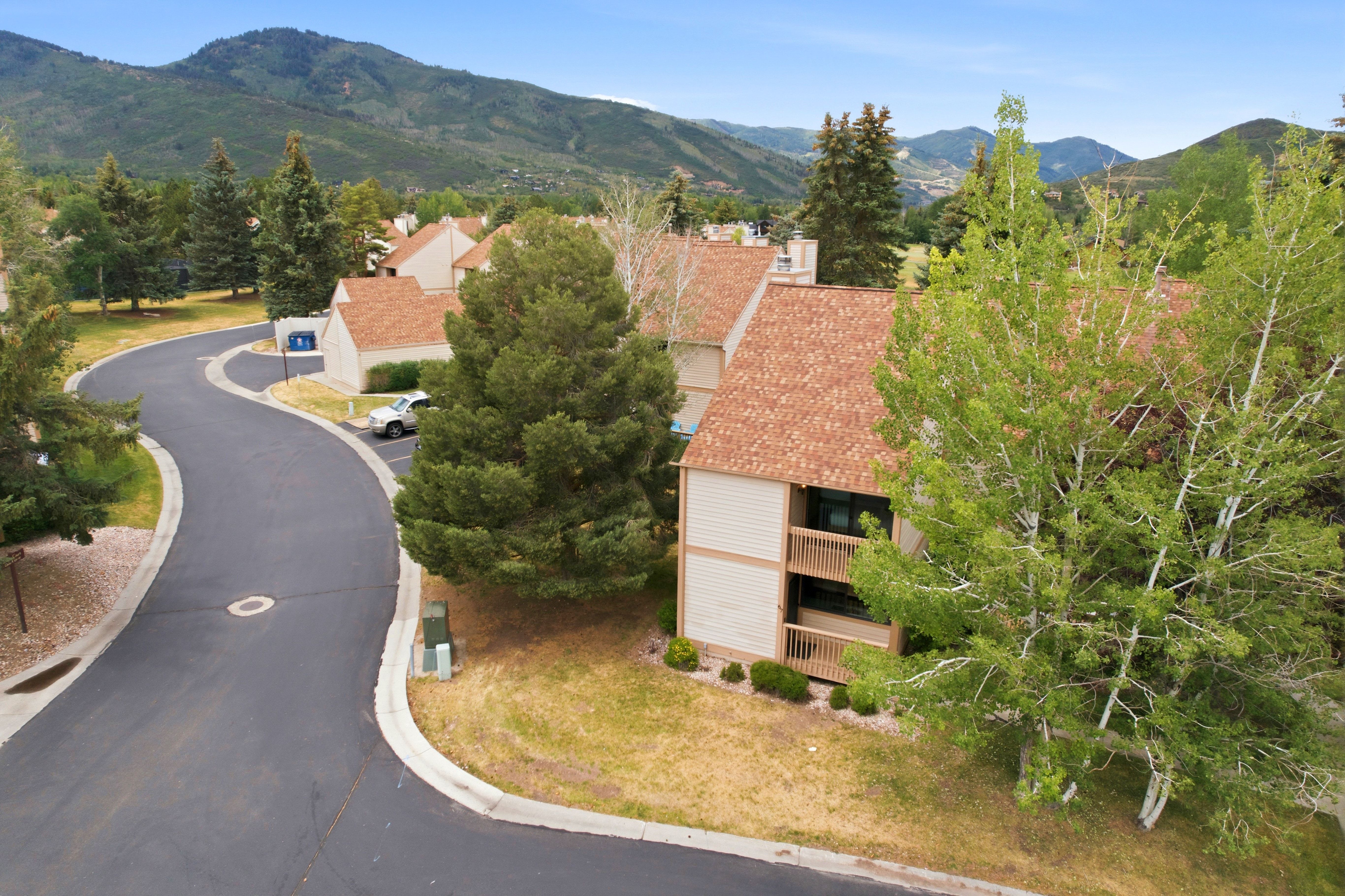 Three-story multi-unit structure featuring light-toned siding and multi-level private balconies
