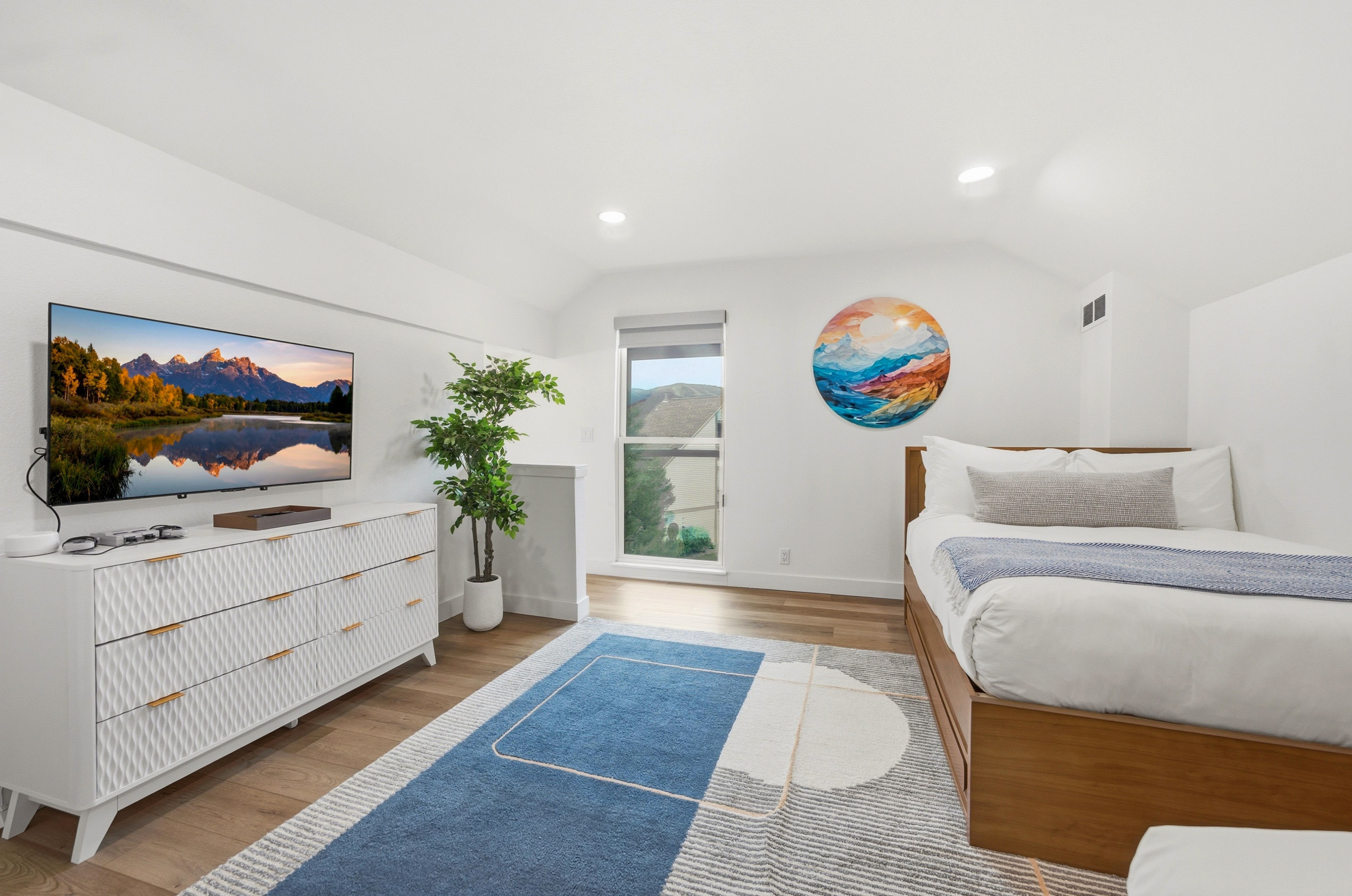 Attic space with high vaulted ceilings and recessed lighting