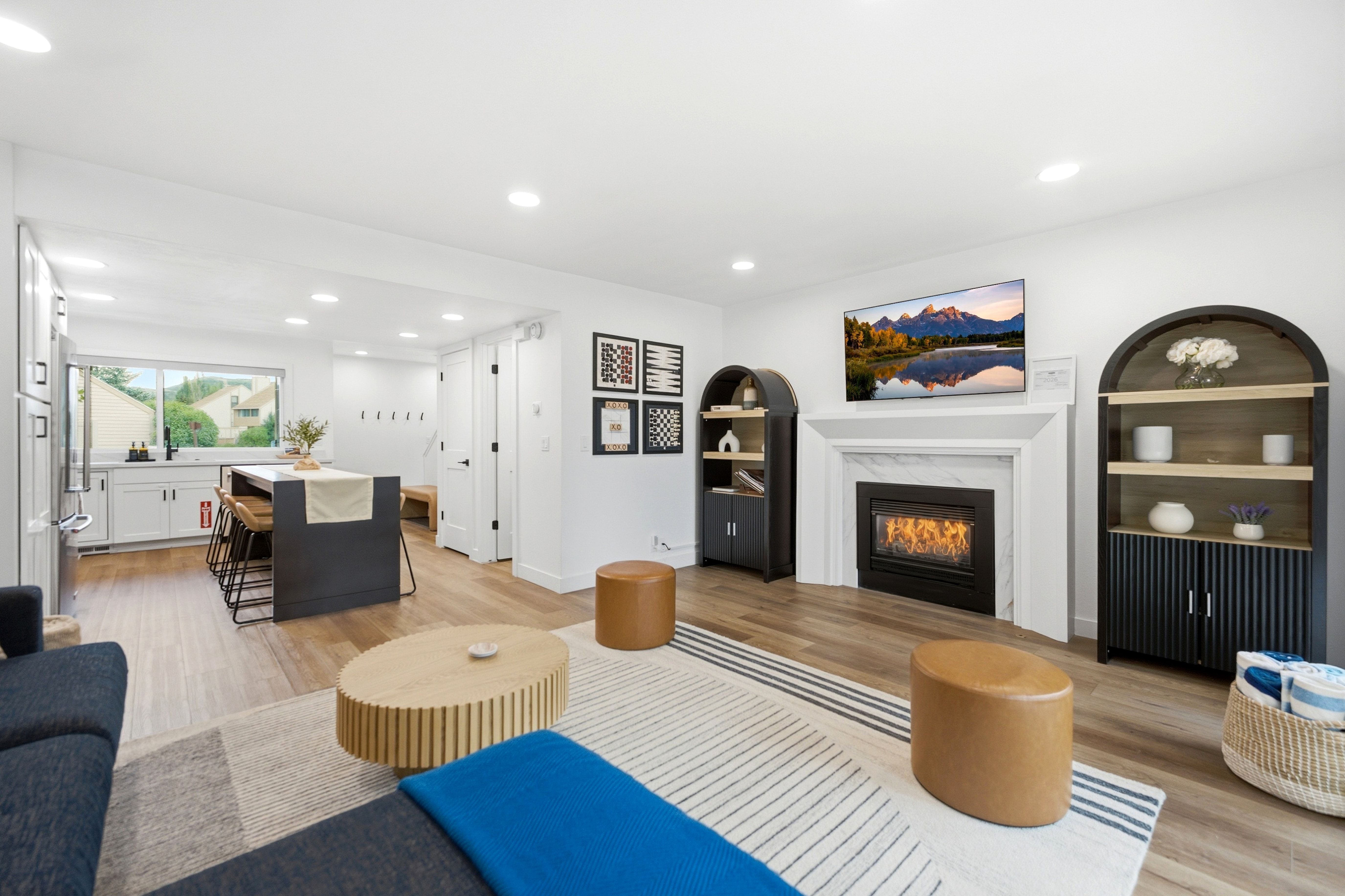 Open-concept living area featuring wood-finish flooring and recessed lighting