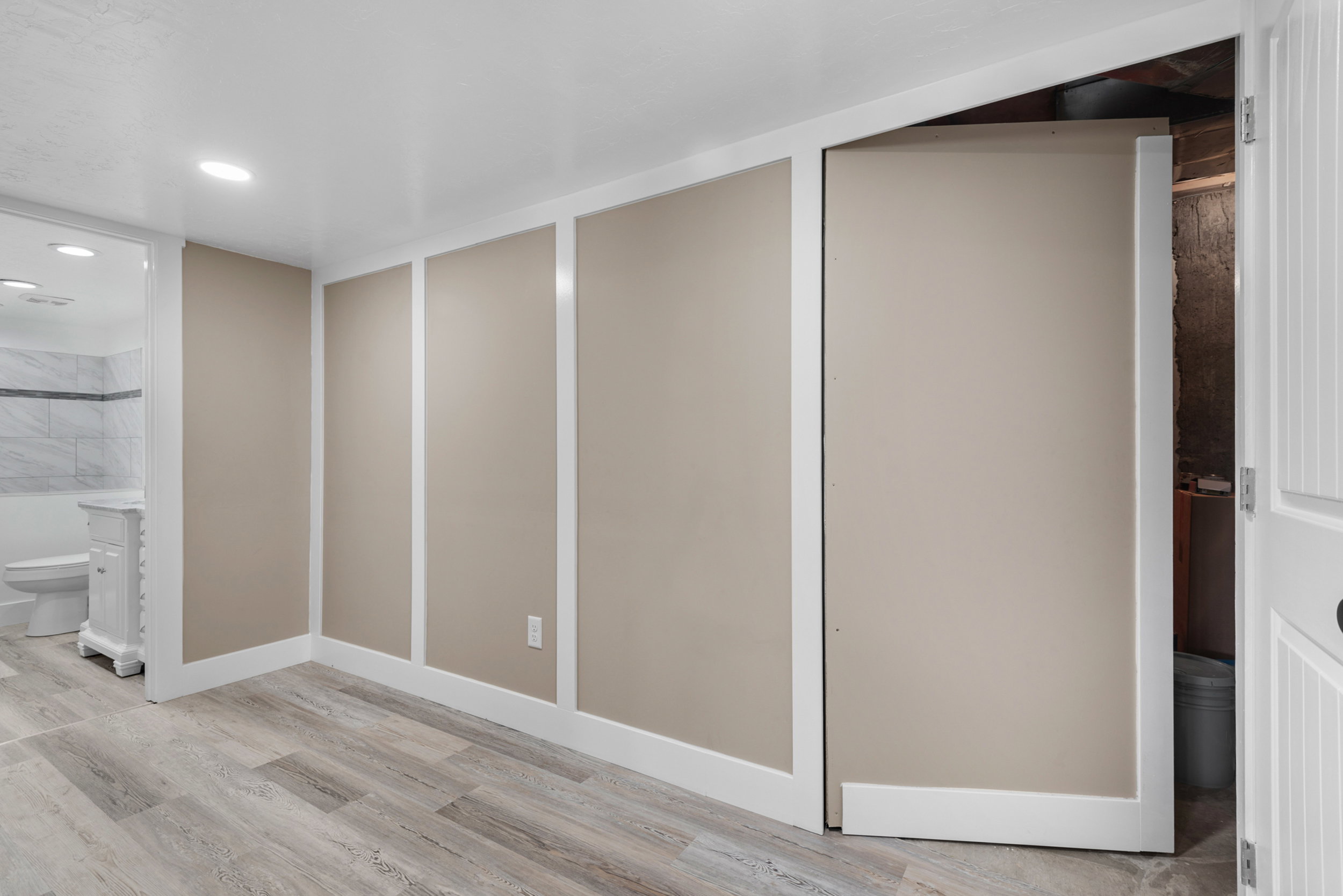 Basement hallway with secret door to utility closet