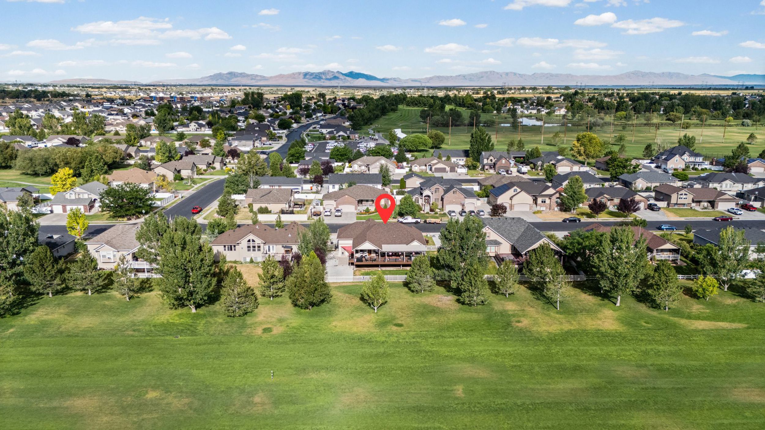 Single-story residential property featuring a covered rear deck and a well-maintained lawn