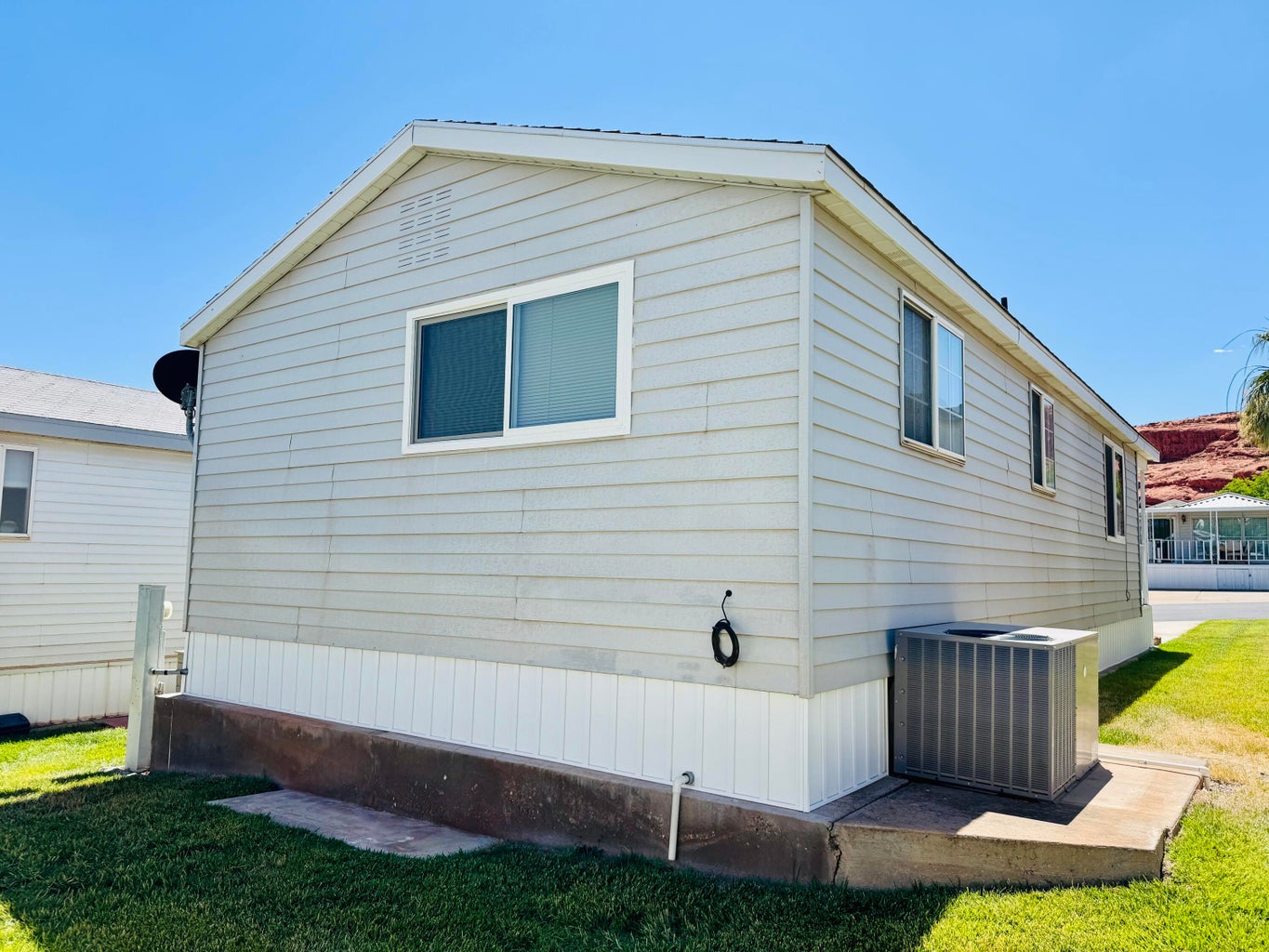Light-colored horizontal siding exterior with white trim
