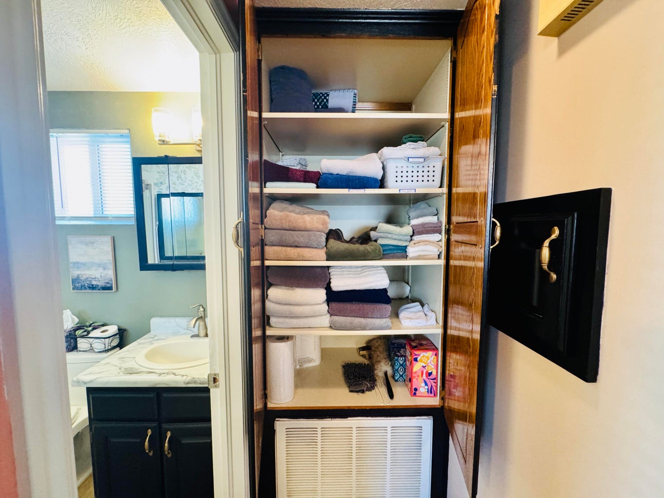 Built-in linen cabinet with multiple shelving units providing organized storage
