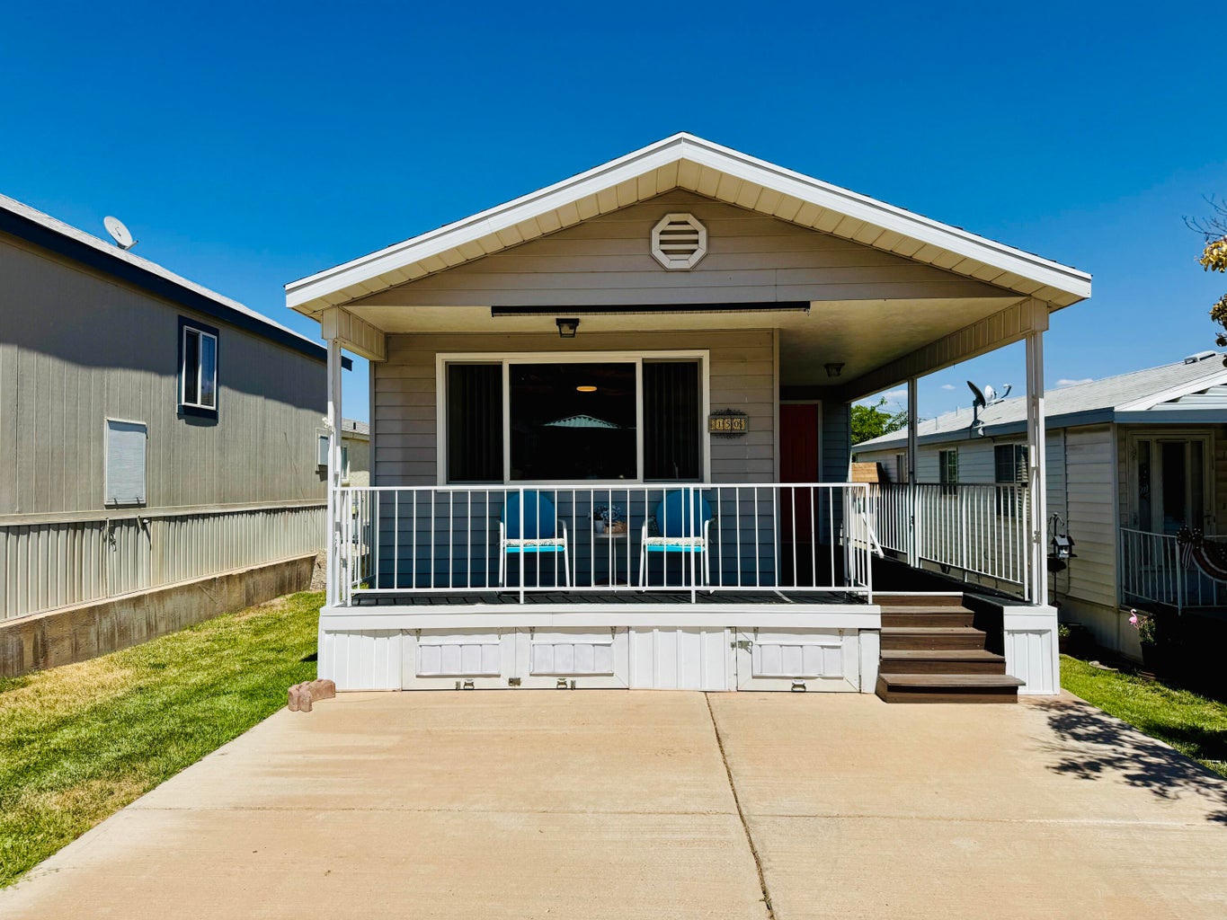 Exterior featuring a covered porch, sliding glass door, and a red entry door
