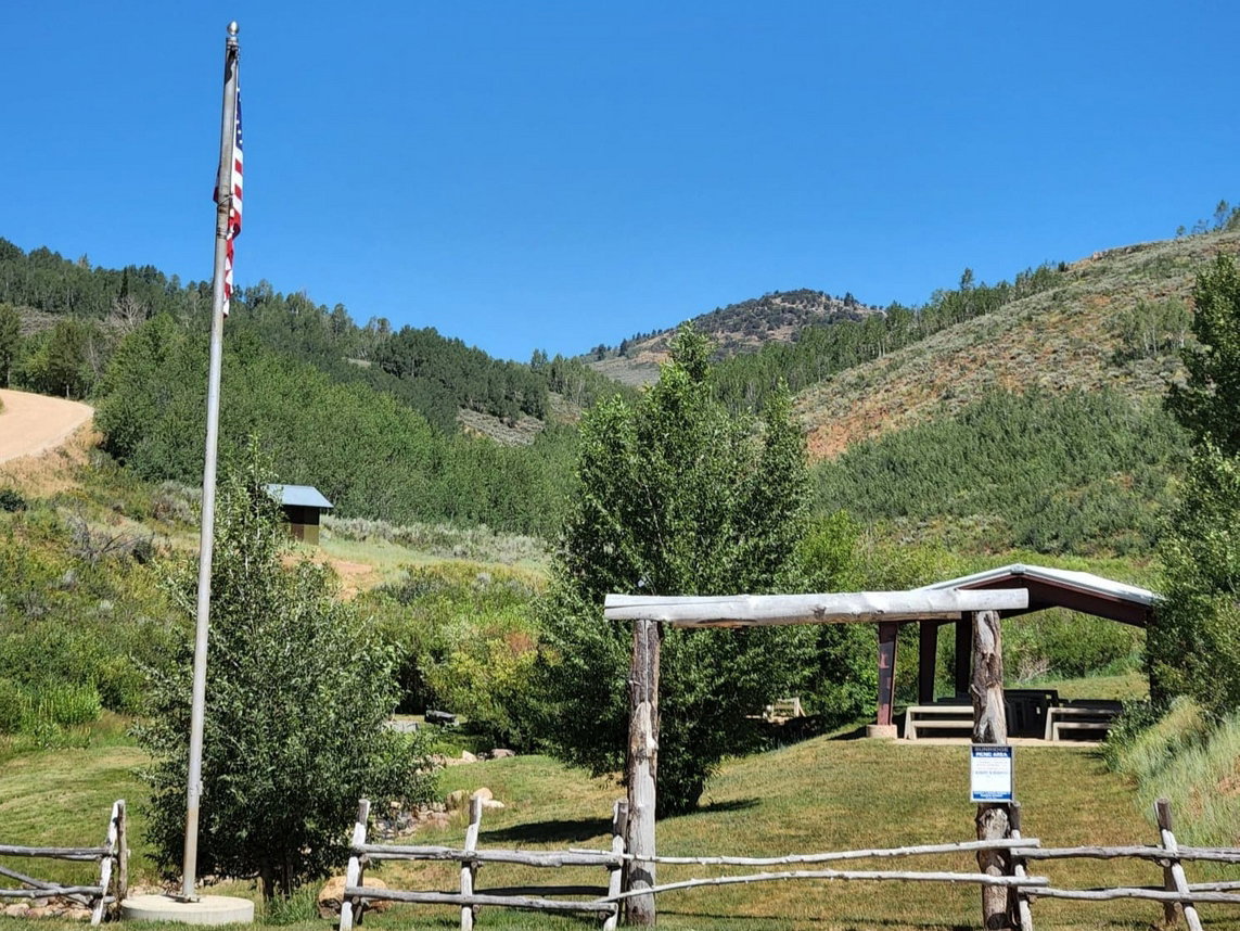 Rustic split-rail fence entrance with a wooden archway