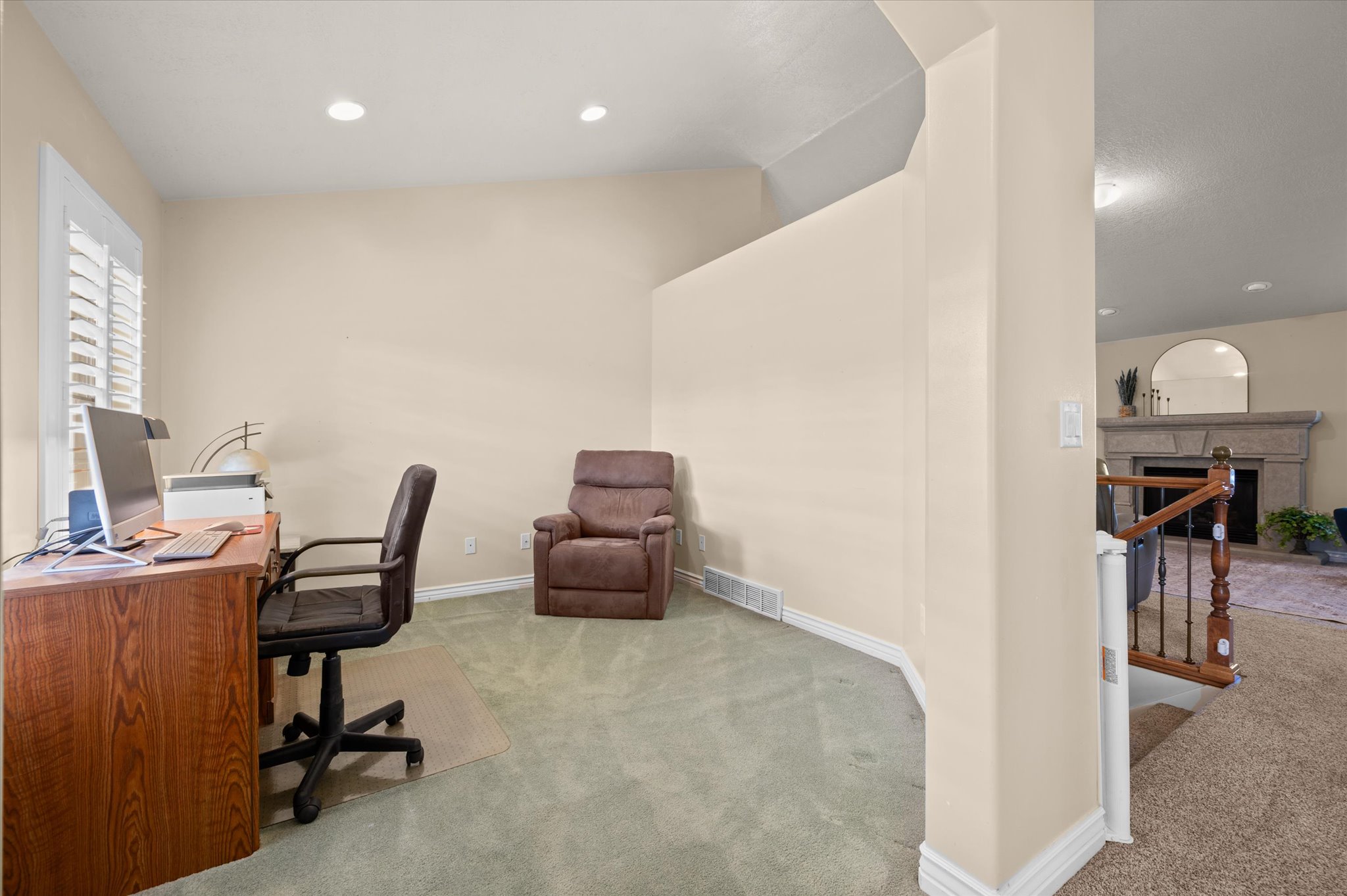 Dedicated office space with recessed lighting, plush carpeting, and window with plantation shutters