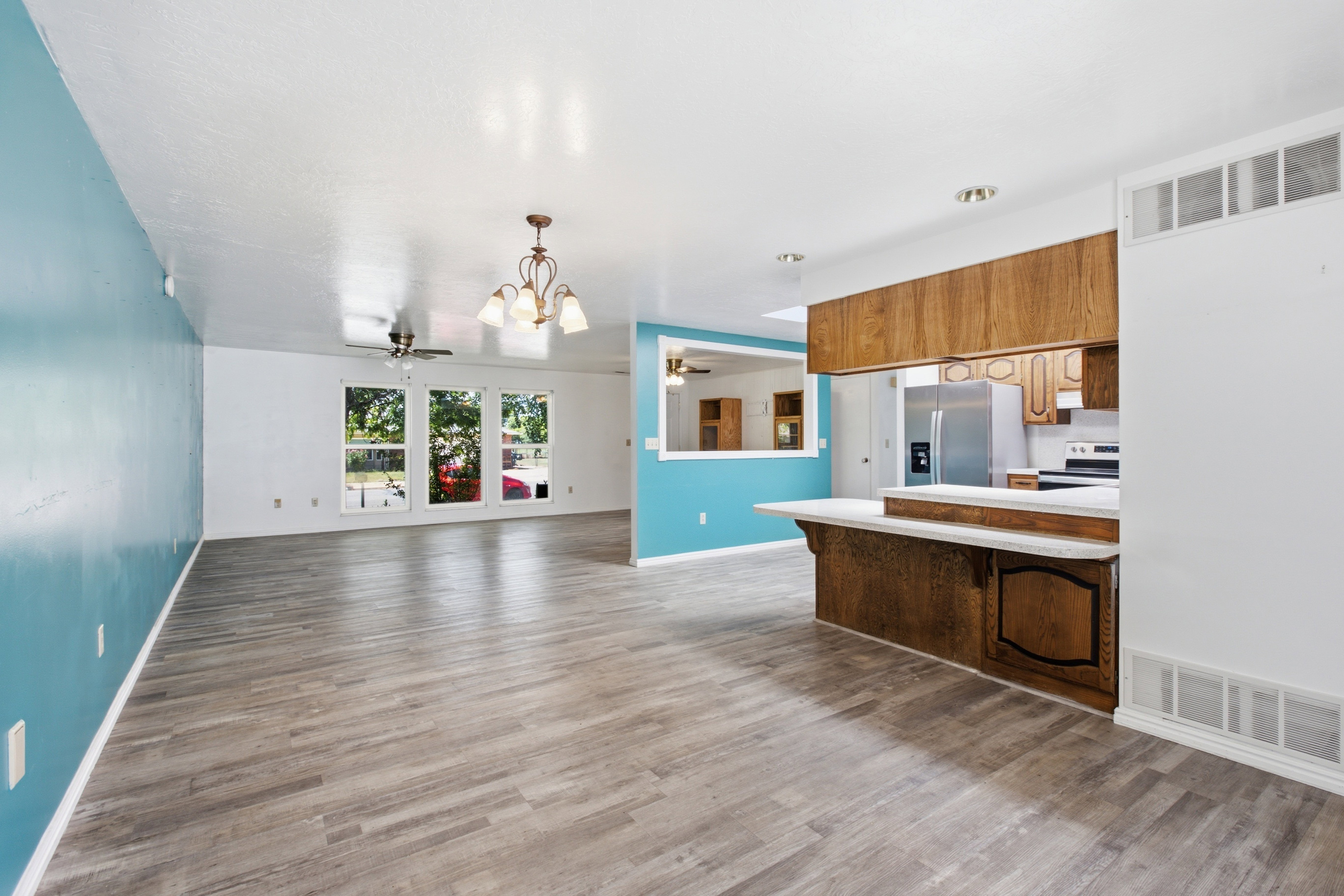 Open concept living area with wood-finish flooring