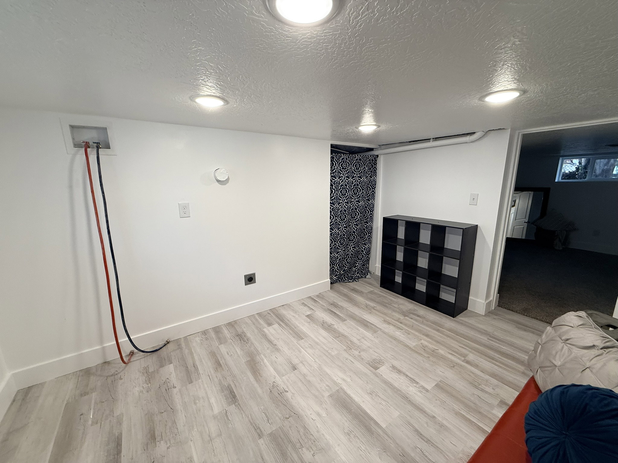 Bright white walls featuring recessed lighting and light wood-finish flooring