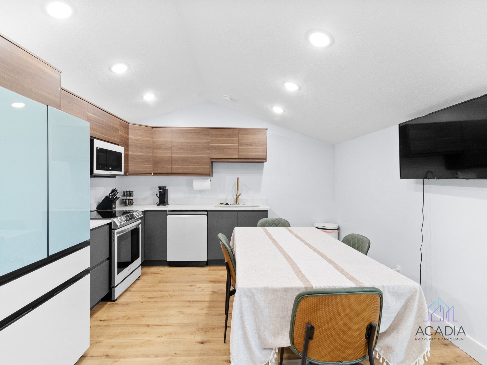 Bright kitchen with wood-finish flooring and recessed lighting