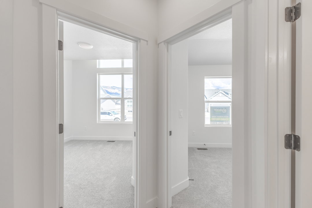 Two rooms featuring neutral-toned carpeting, white walls, and white trim