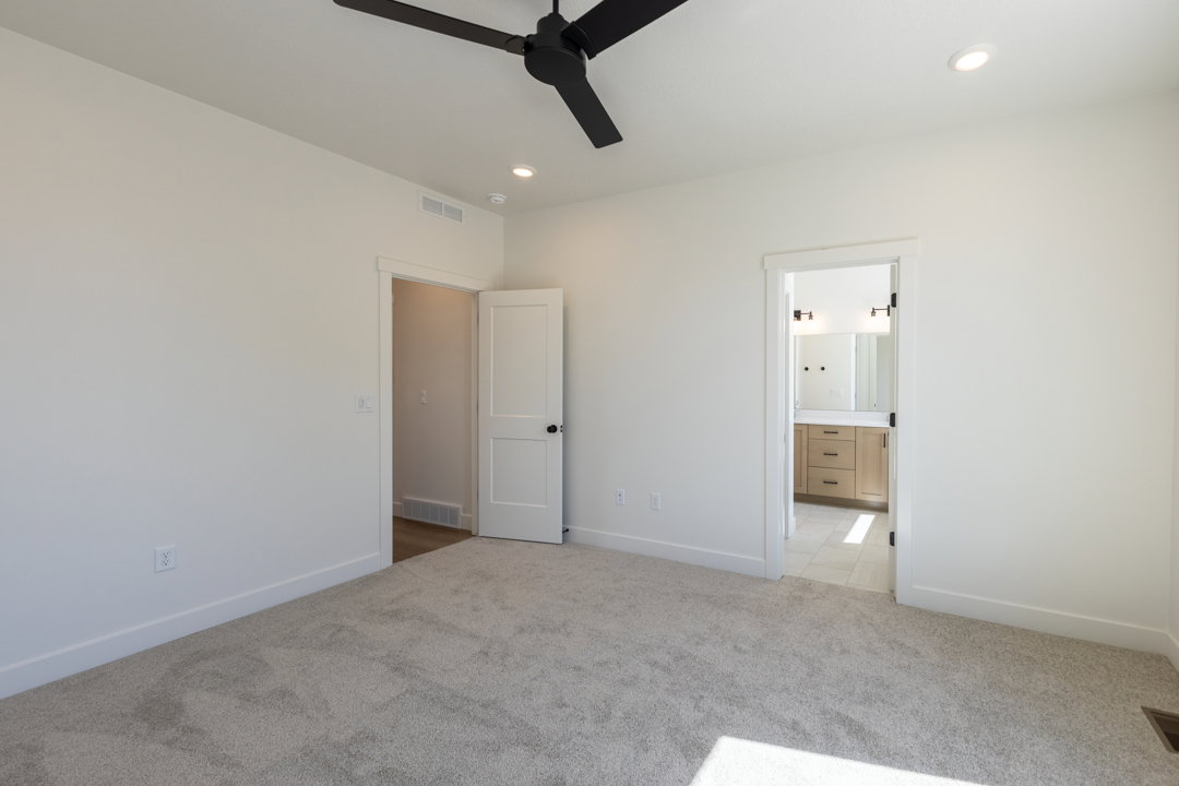Spacious room with light neutral carpet and white walls