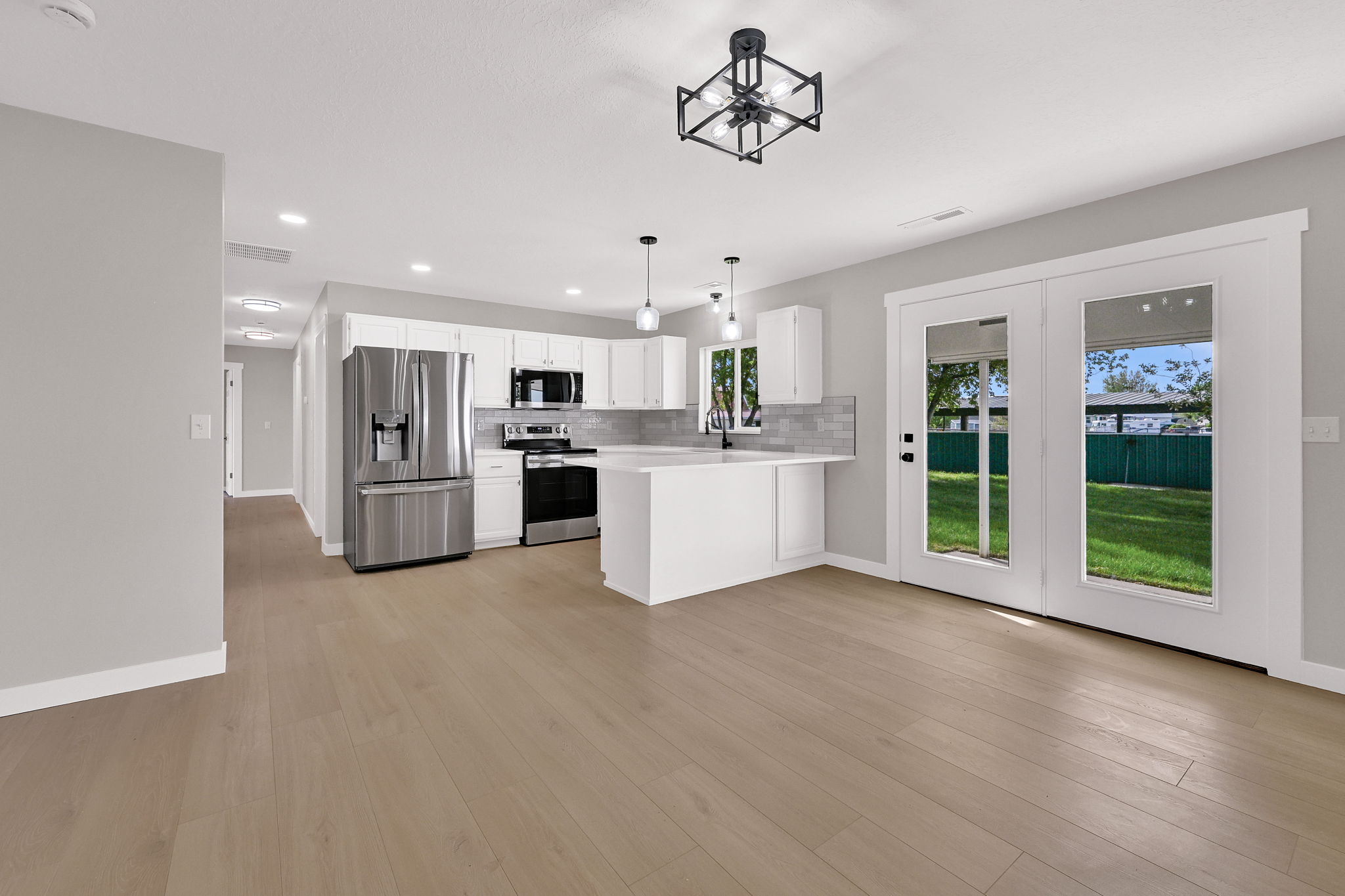 Open-concept living space with wood-finish flooring