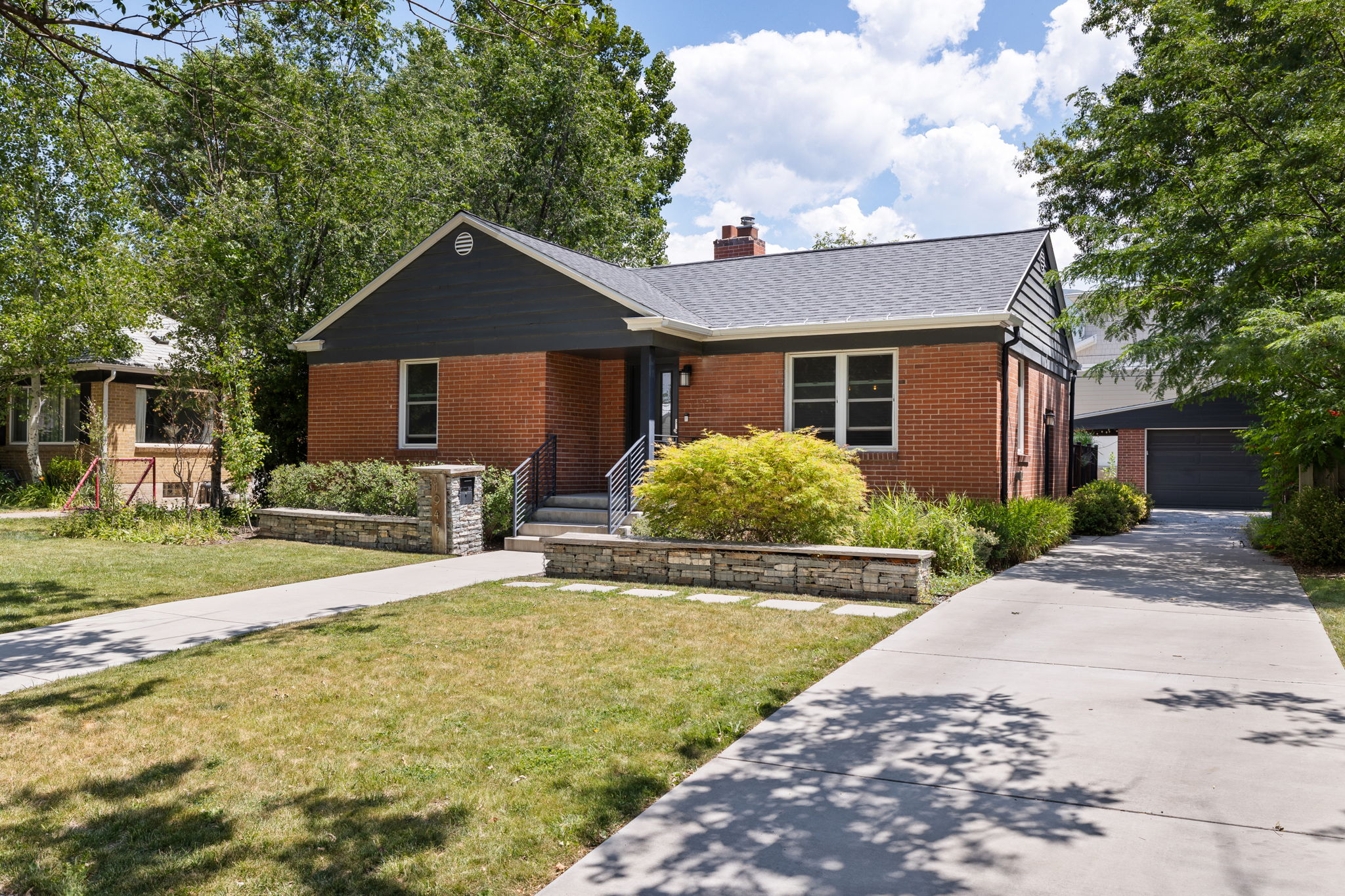 Brick exterior with dark siding accents and a contrasting roof